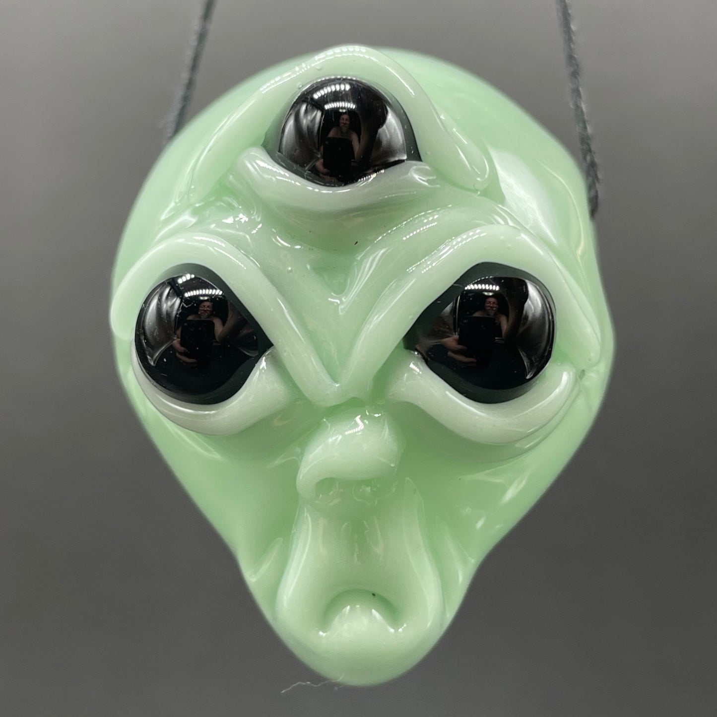 Time manipulating three eye glass alien pendant