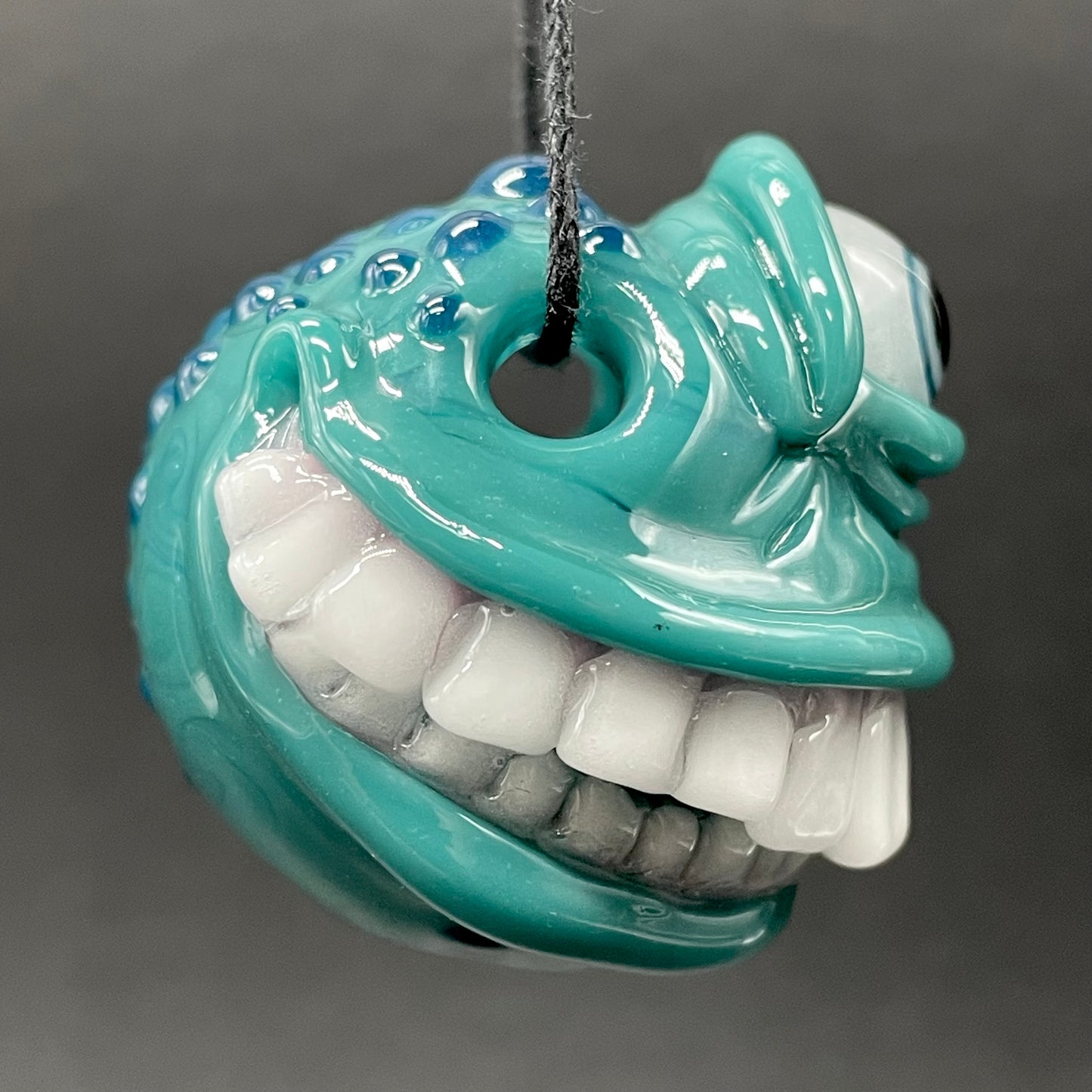 Grinning like a fool glass pendant