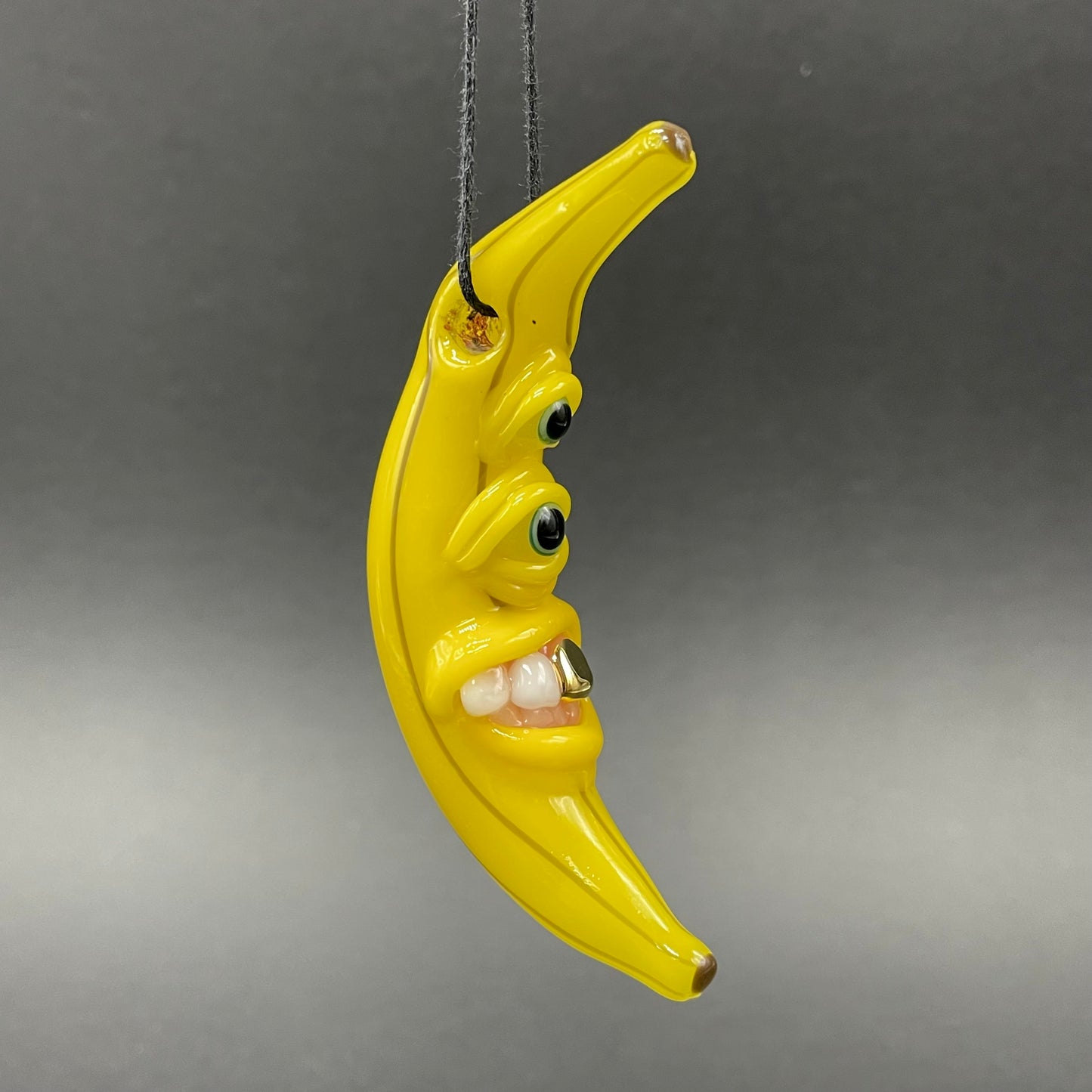 Grinning glass banana pendant