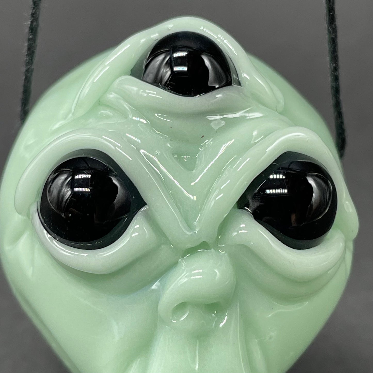 Time manipulating three eye glass alien pendant