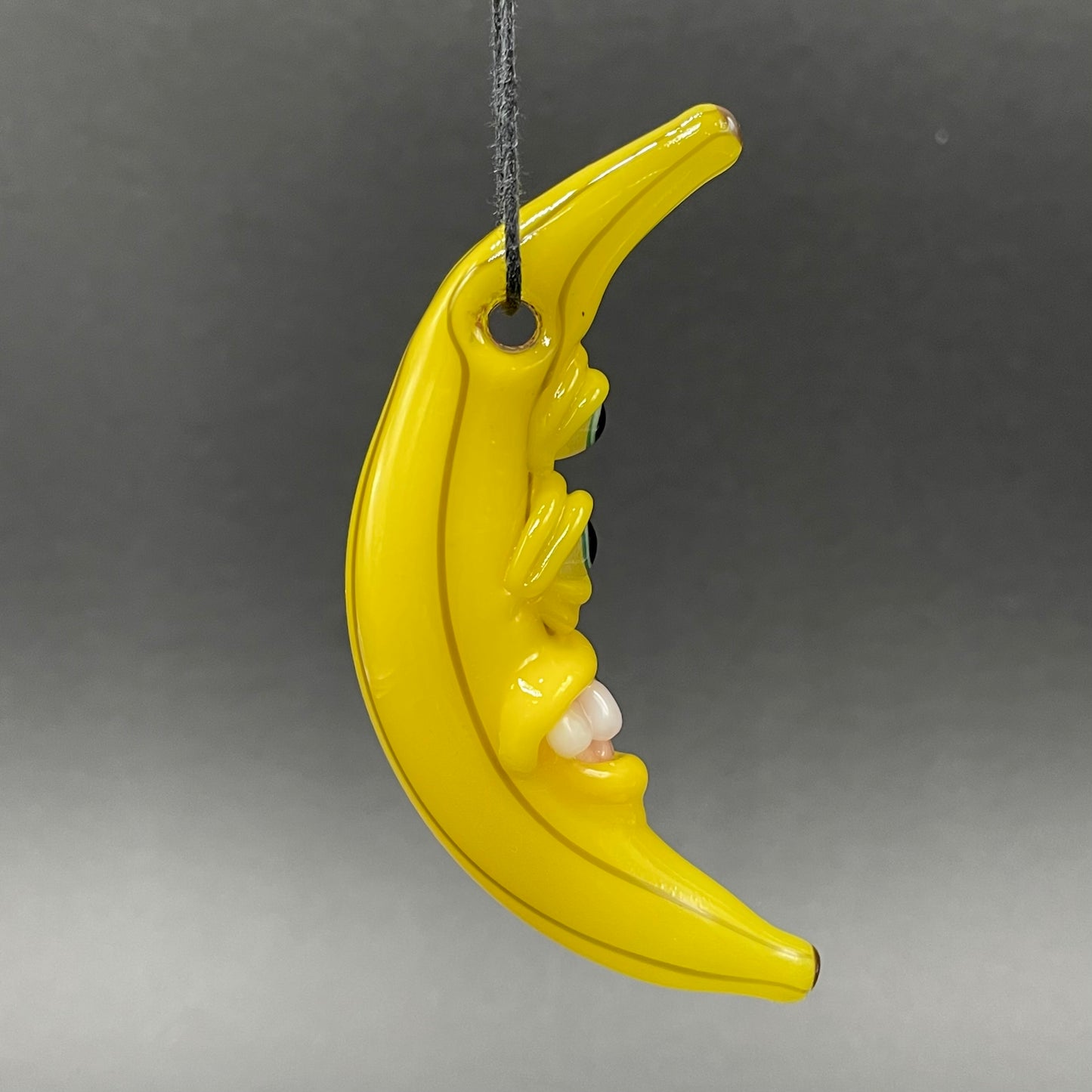 Grinning glass banana pendant