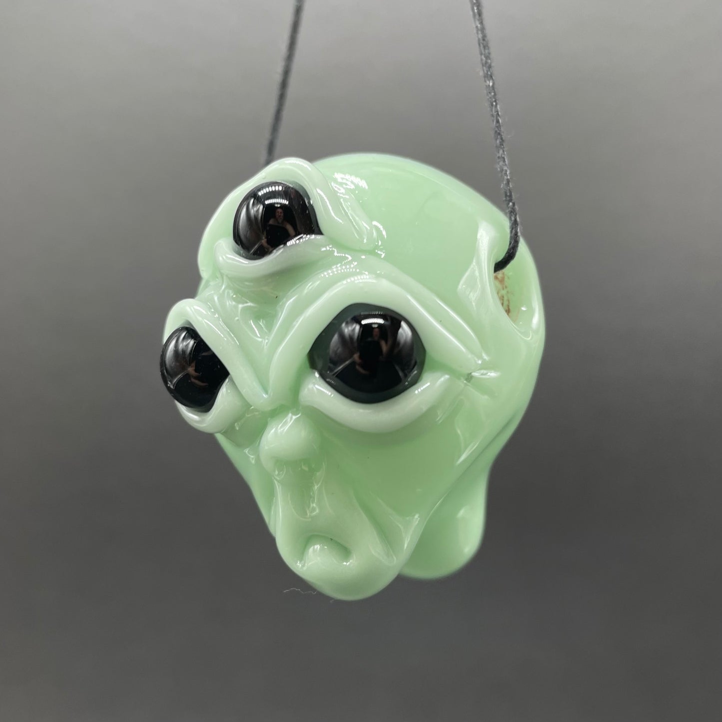 Time manipulating three eye glass alien pendant