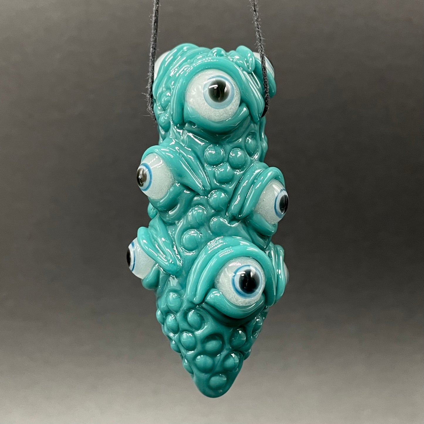 The Never-Blinking One glass effigy pendant