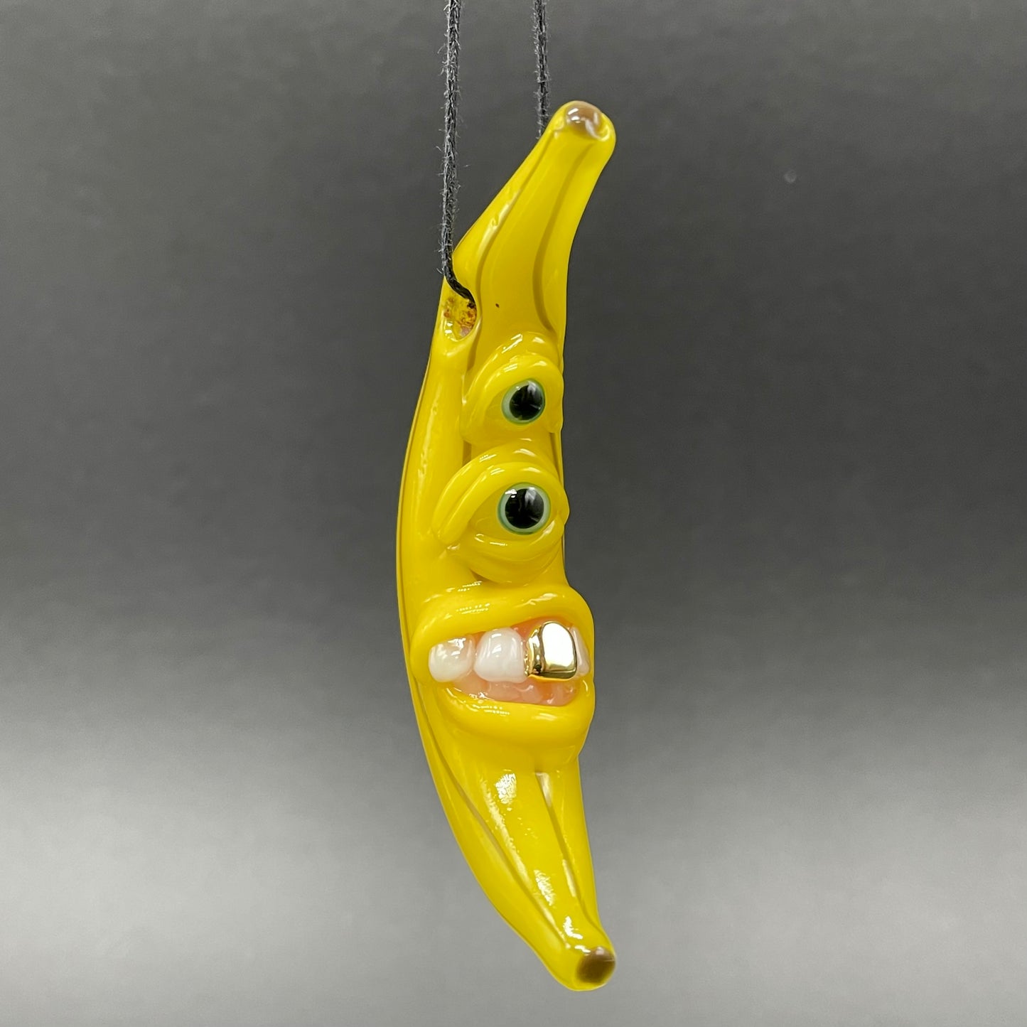 Grinning glass banana pendant