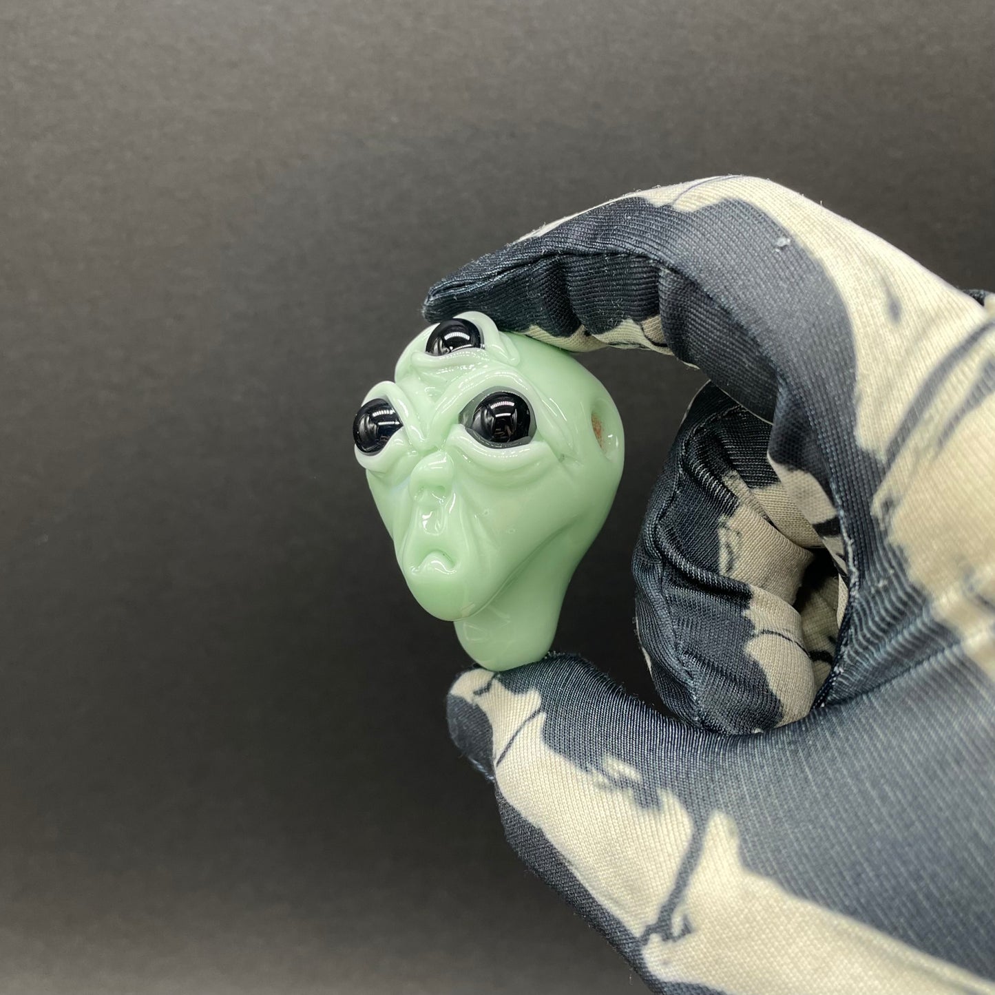 Time manipulating three eye glass alien pendant