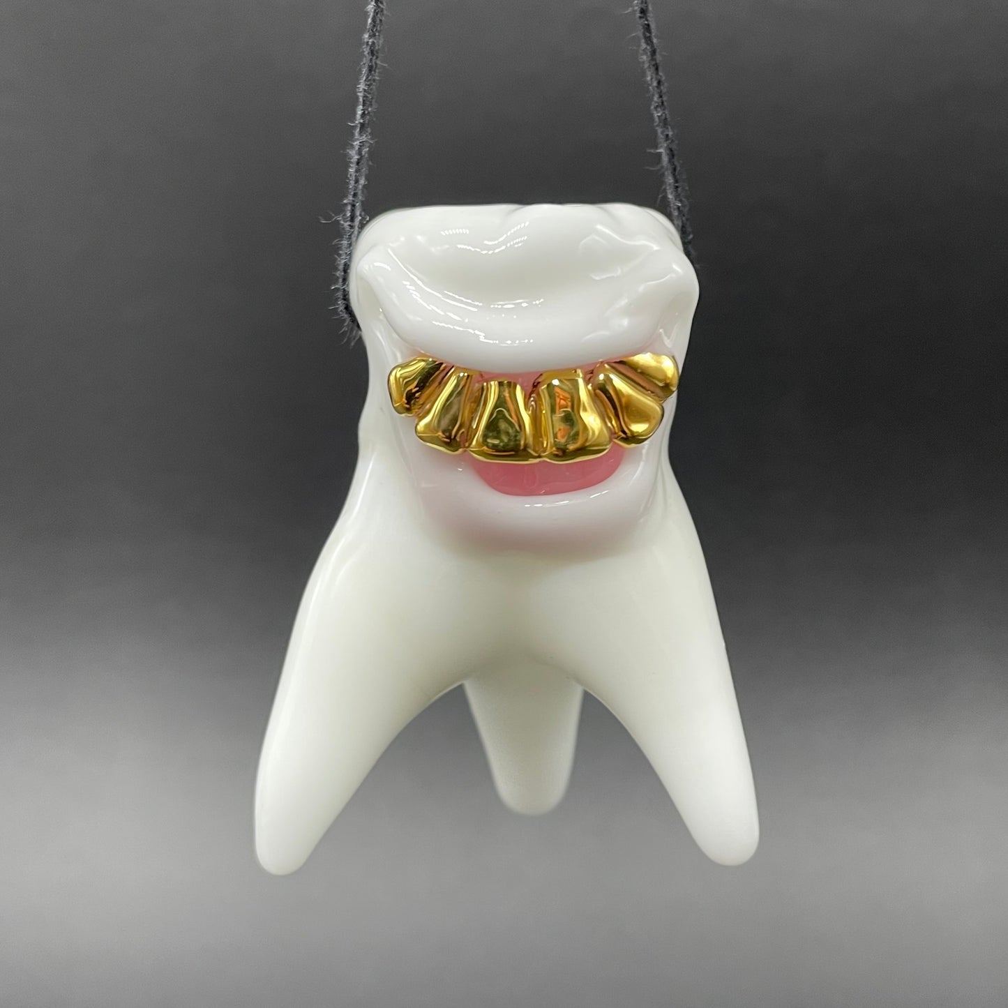 Tooth ache glass pendant