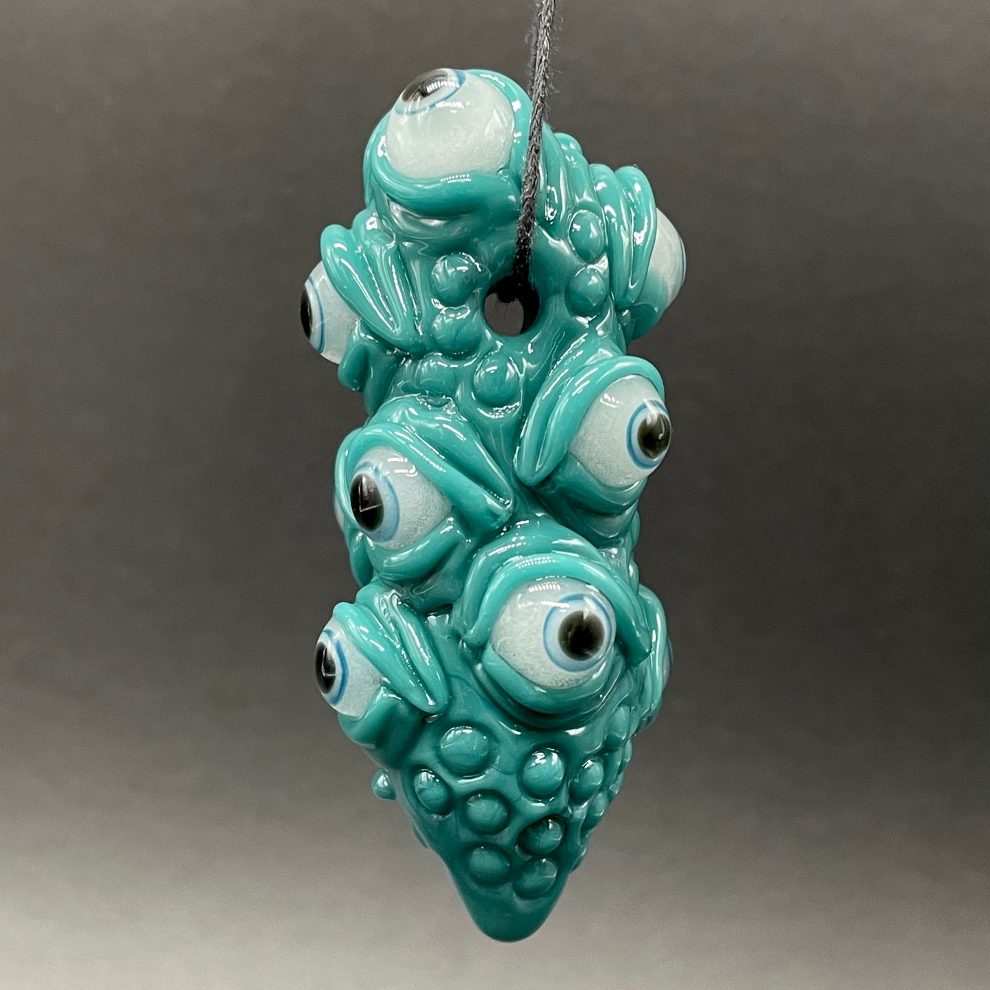 The Never-Blinking One glass effigy pendant