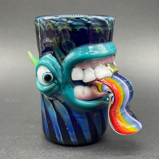 Hand blown kool AID tongue shot glass with gold tooth