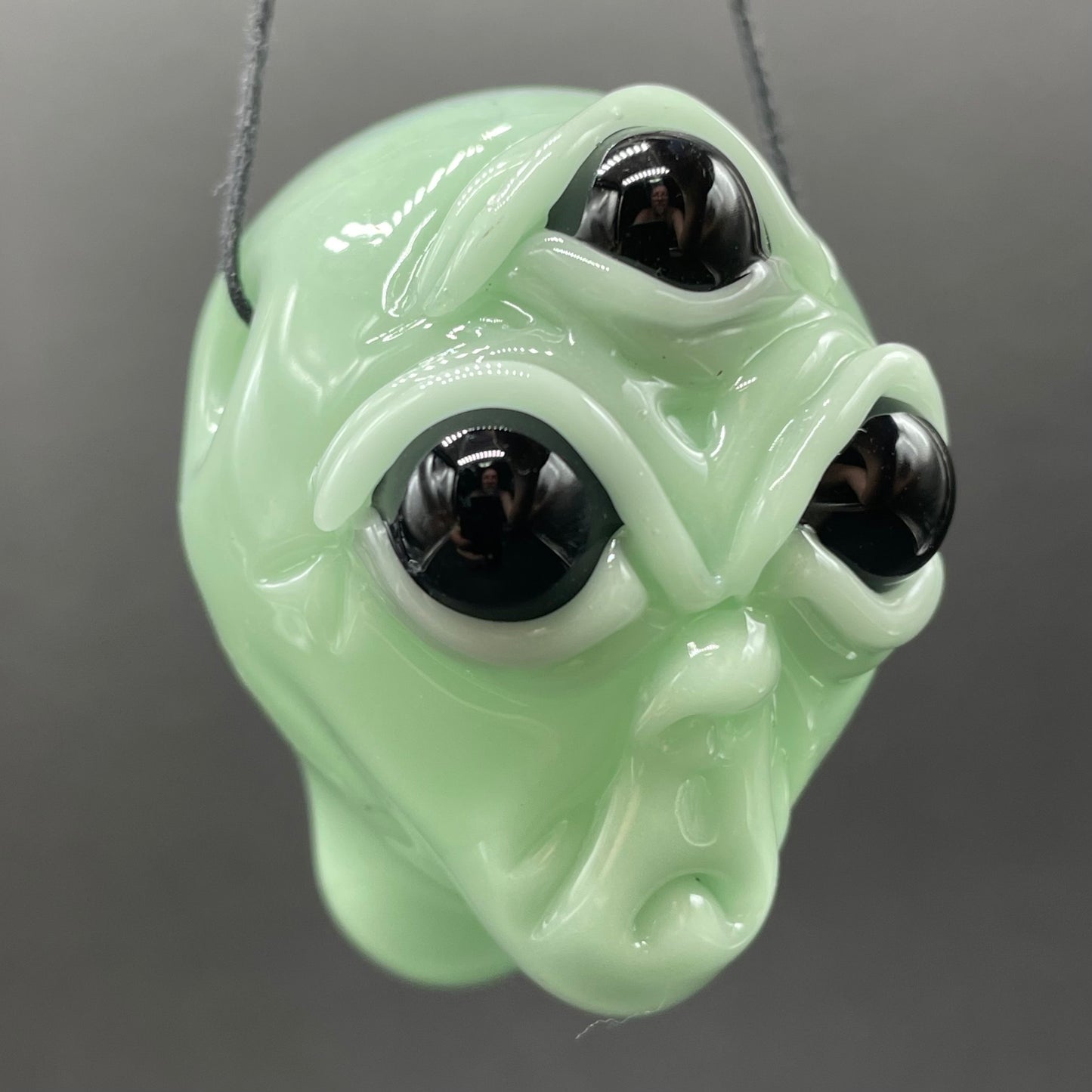 Time manipulating three eye glass alien pendant