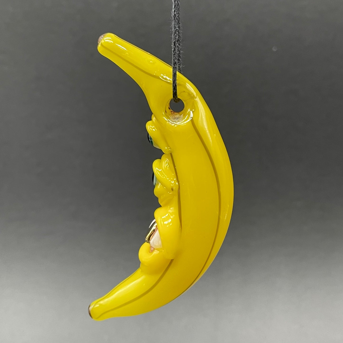 Grinning glass banana pendant