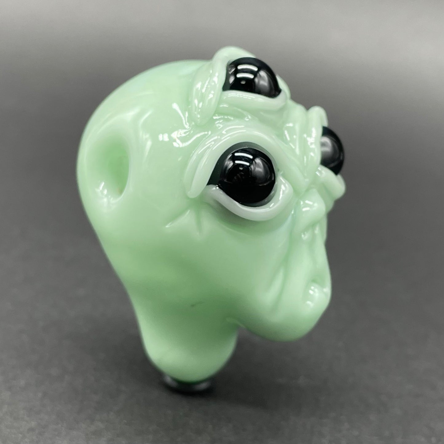 Time manipulating three eye glass alien pendant