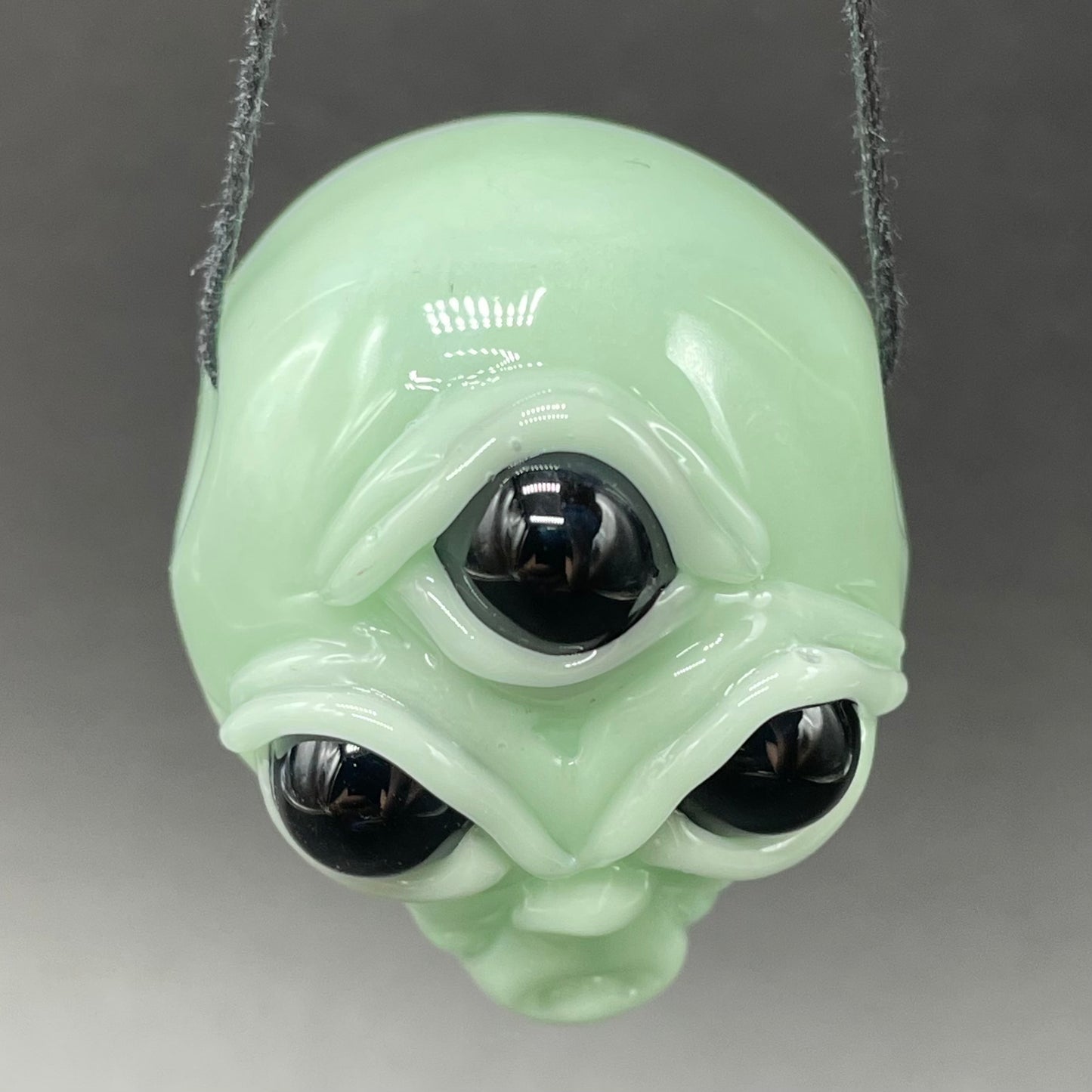 Time manipulating three eye glass alien pendant