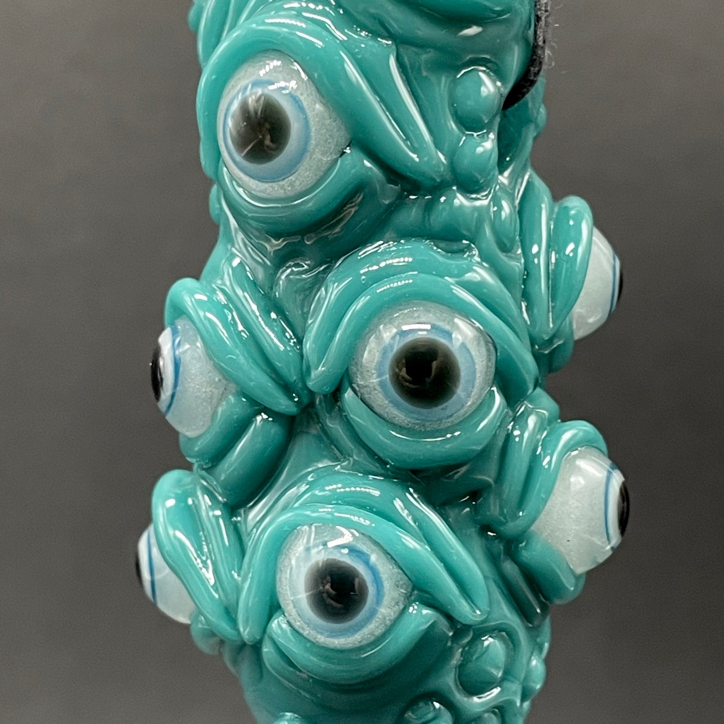 The Never-Blinking One glass effigy pendant