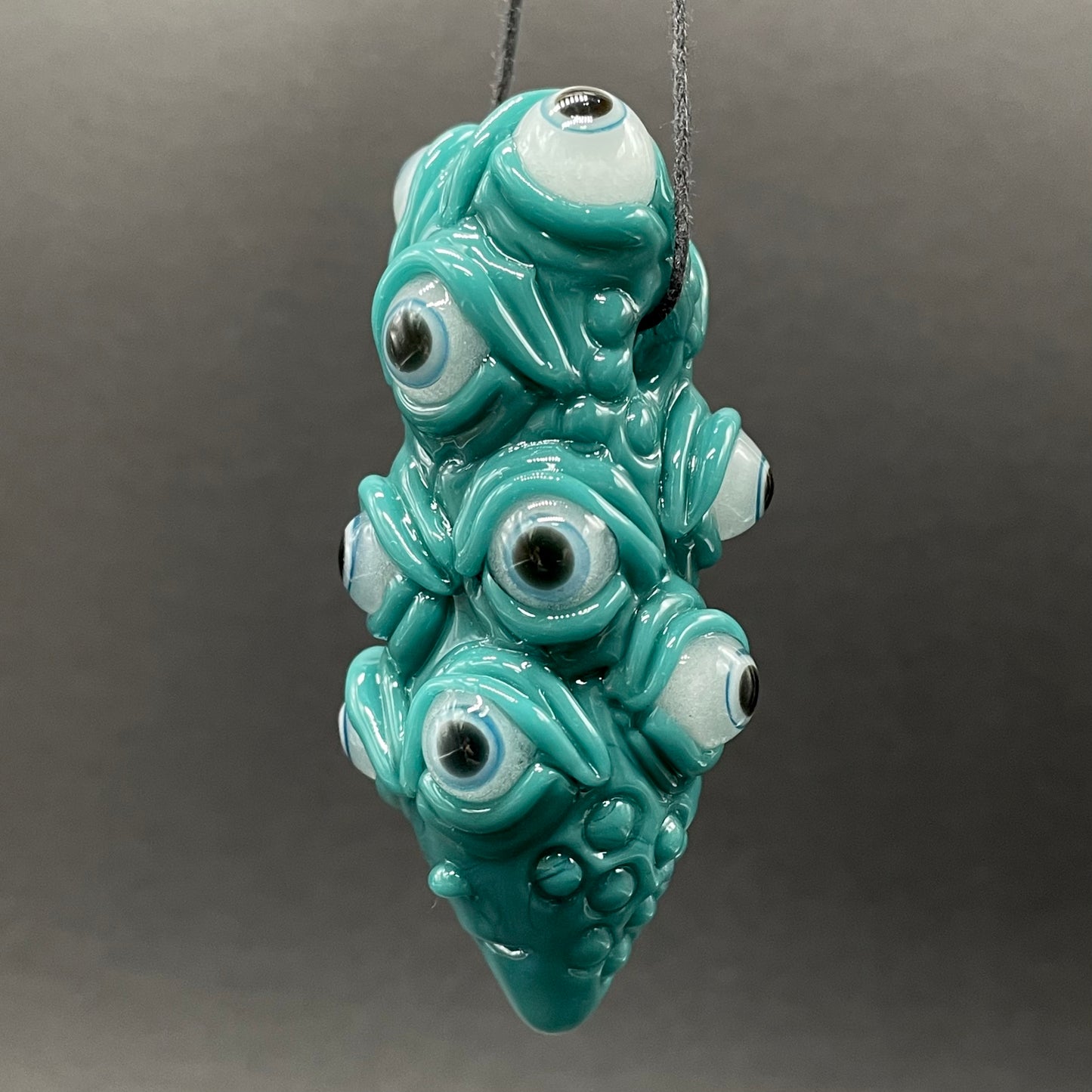 The Never-Blinking One glass effigy pendant
