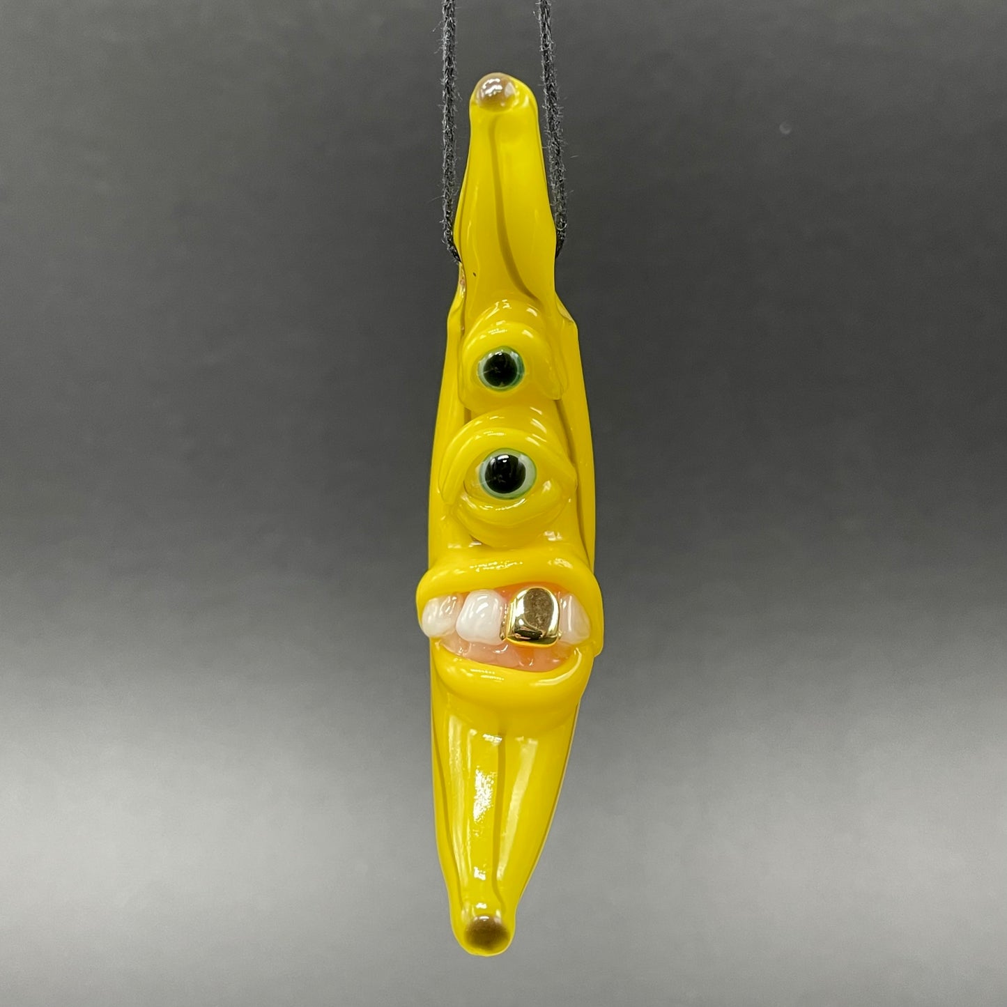Grinning glass banana pendant