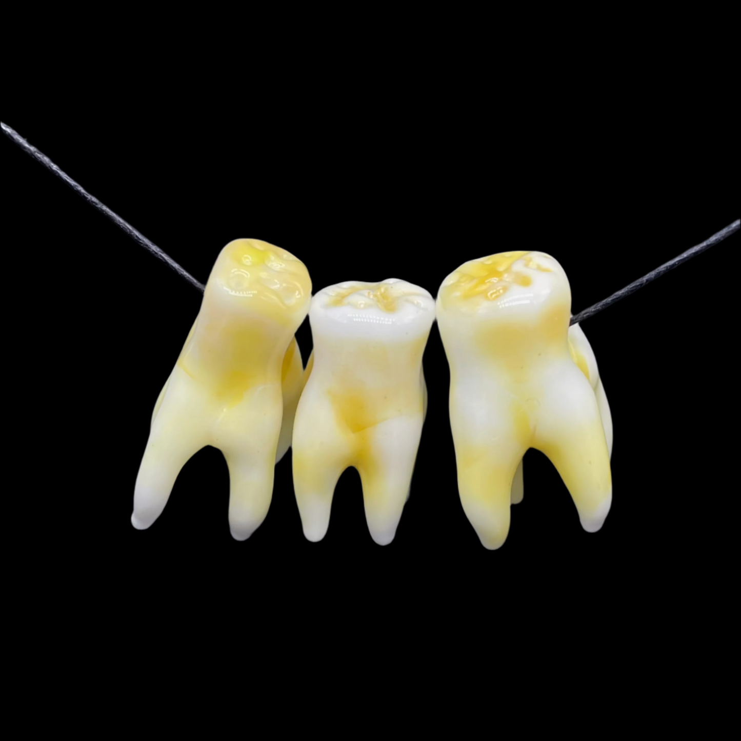 3 glass tooth beads