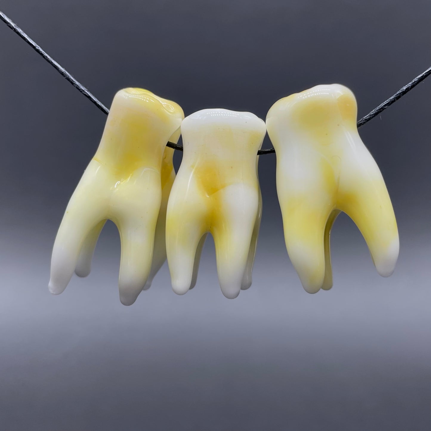 3 glass tooth beads