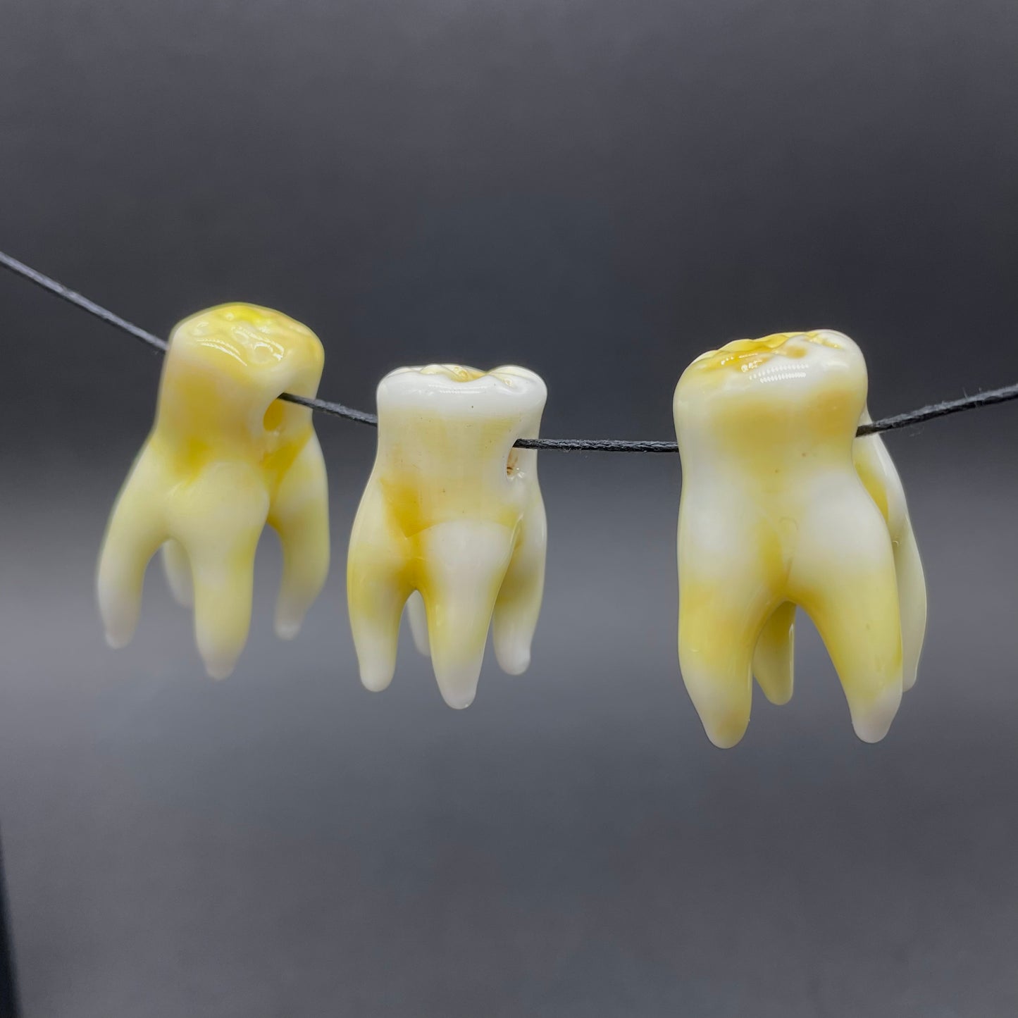 3 glass tooth beads