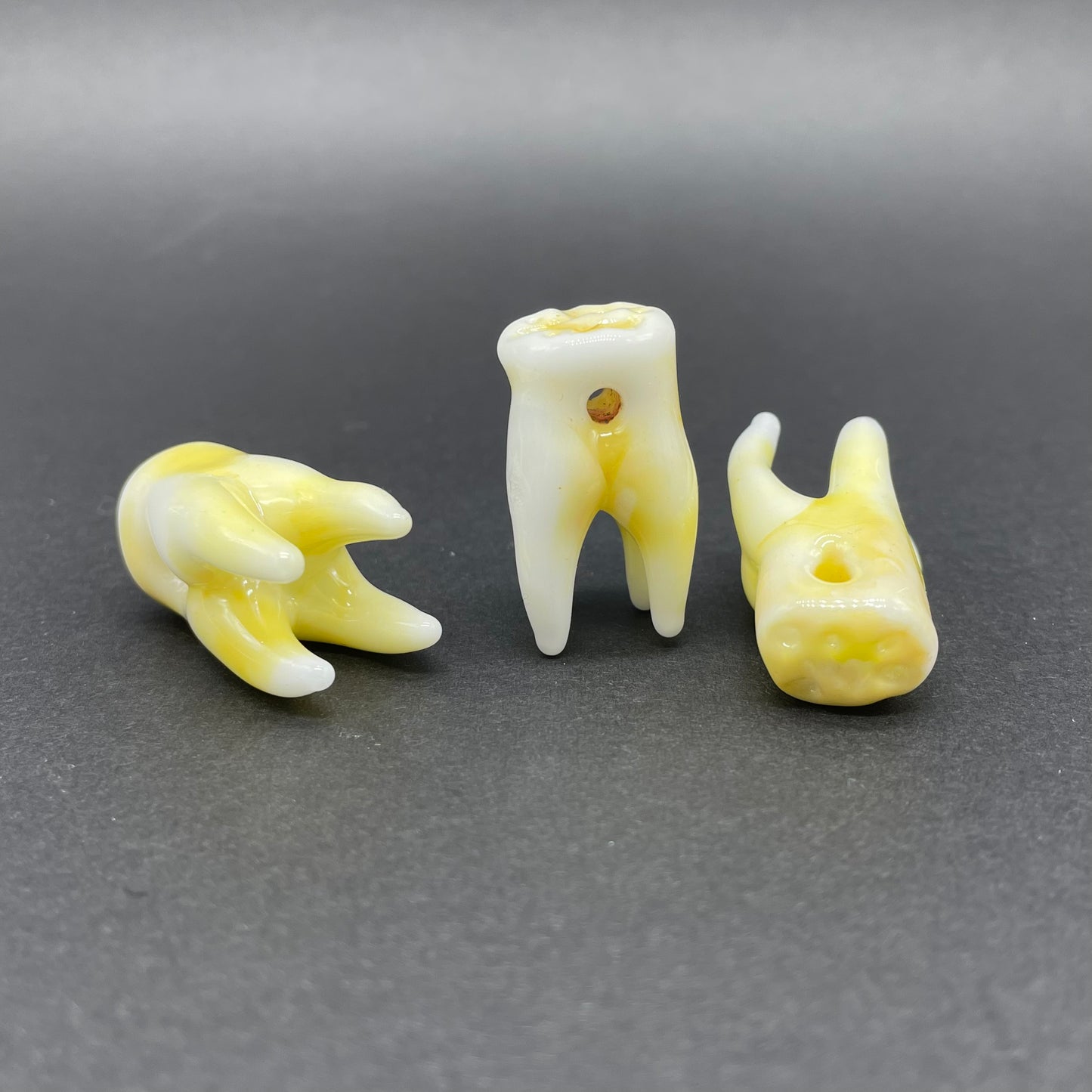 3 glass tooth beads