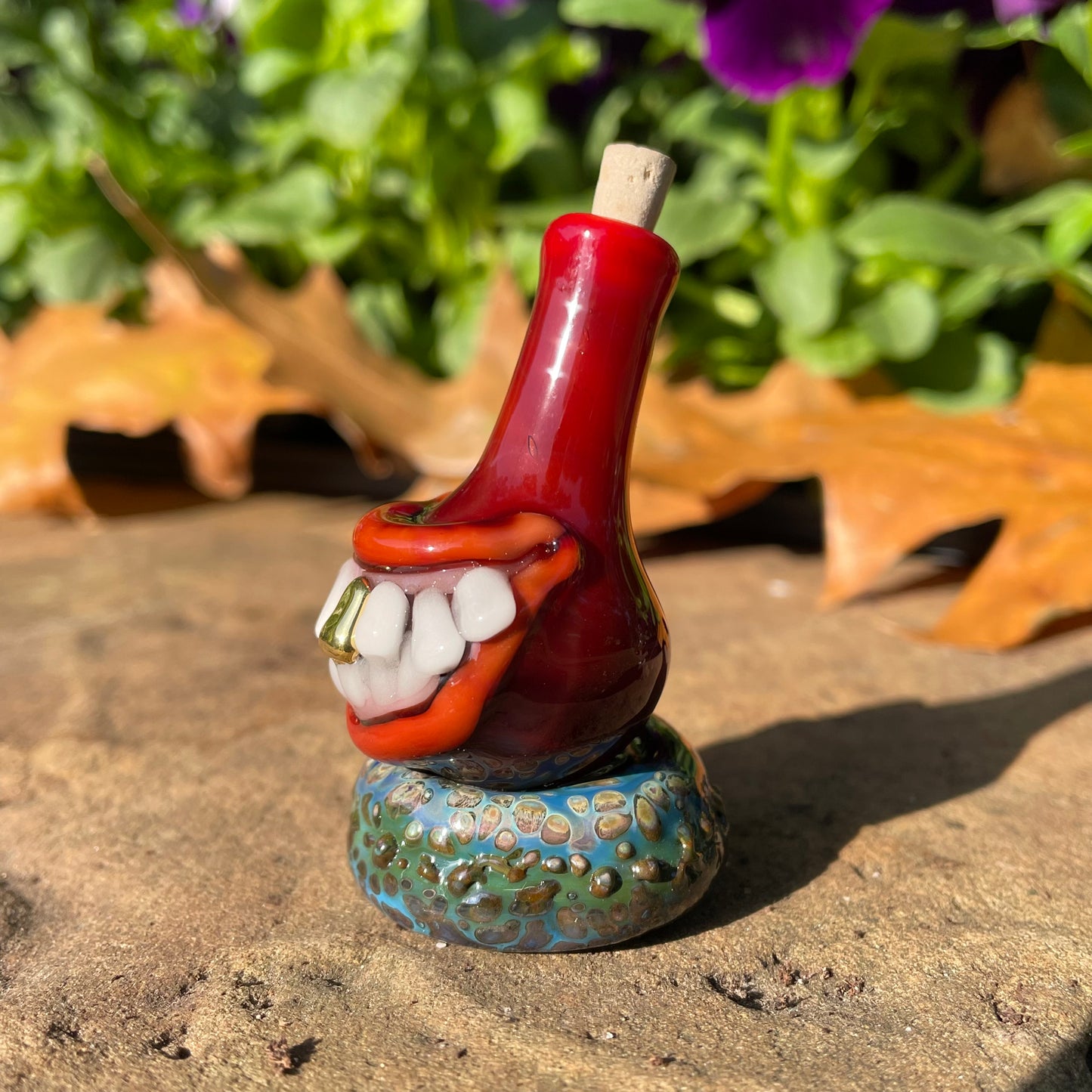 Red grinning glass cork bottle