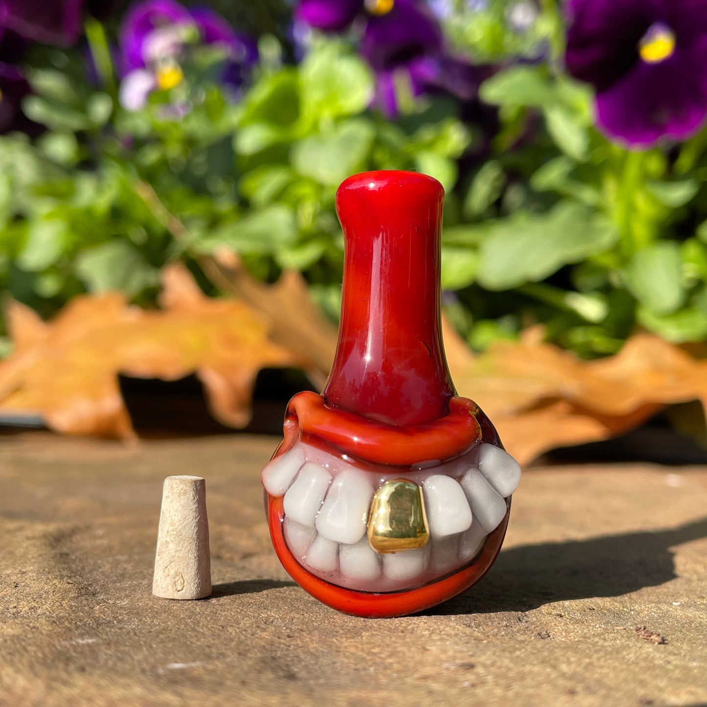 Red grinning glass cork bottle