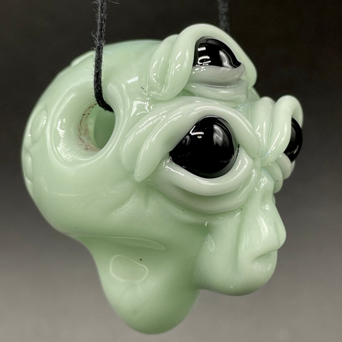 Time manipulating three eye glass alien pendant