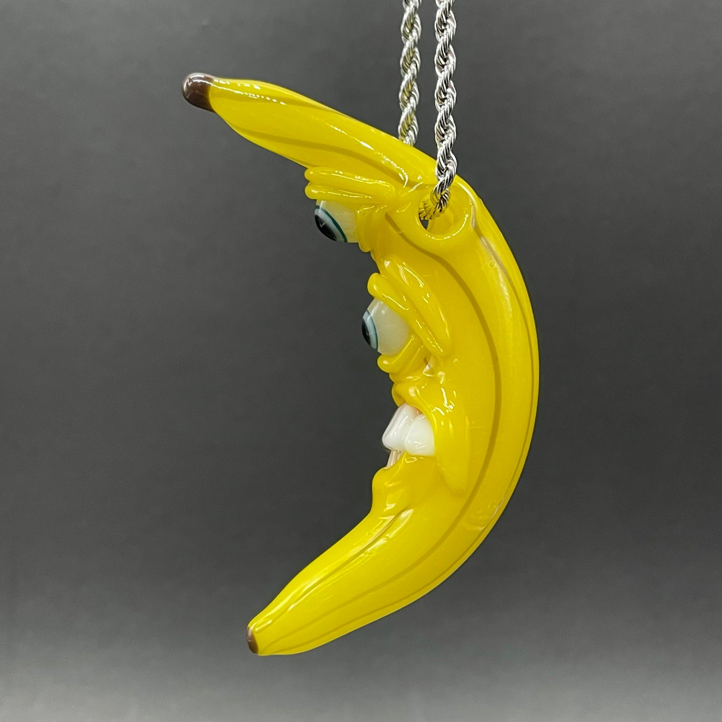 Grinning glass banana pendant