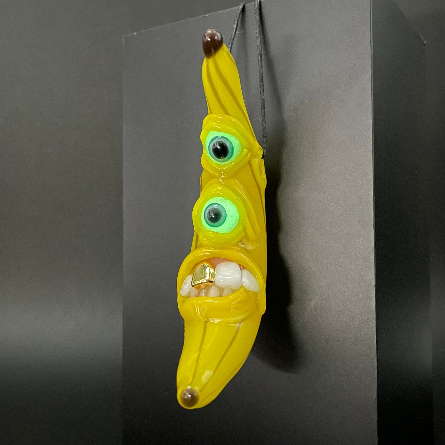 Grinning glass banana pendant
