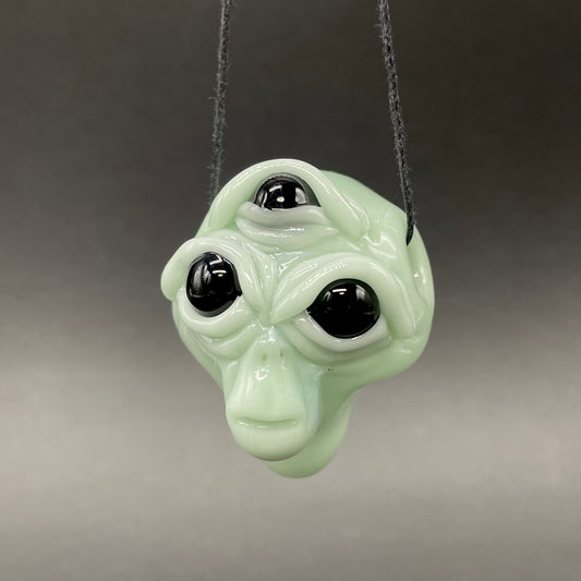 Time manipulating three eye glass alien pendant