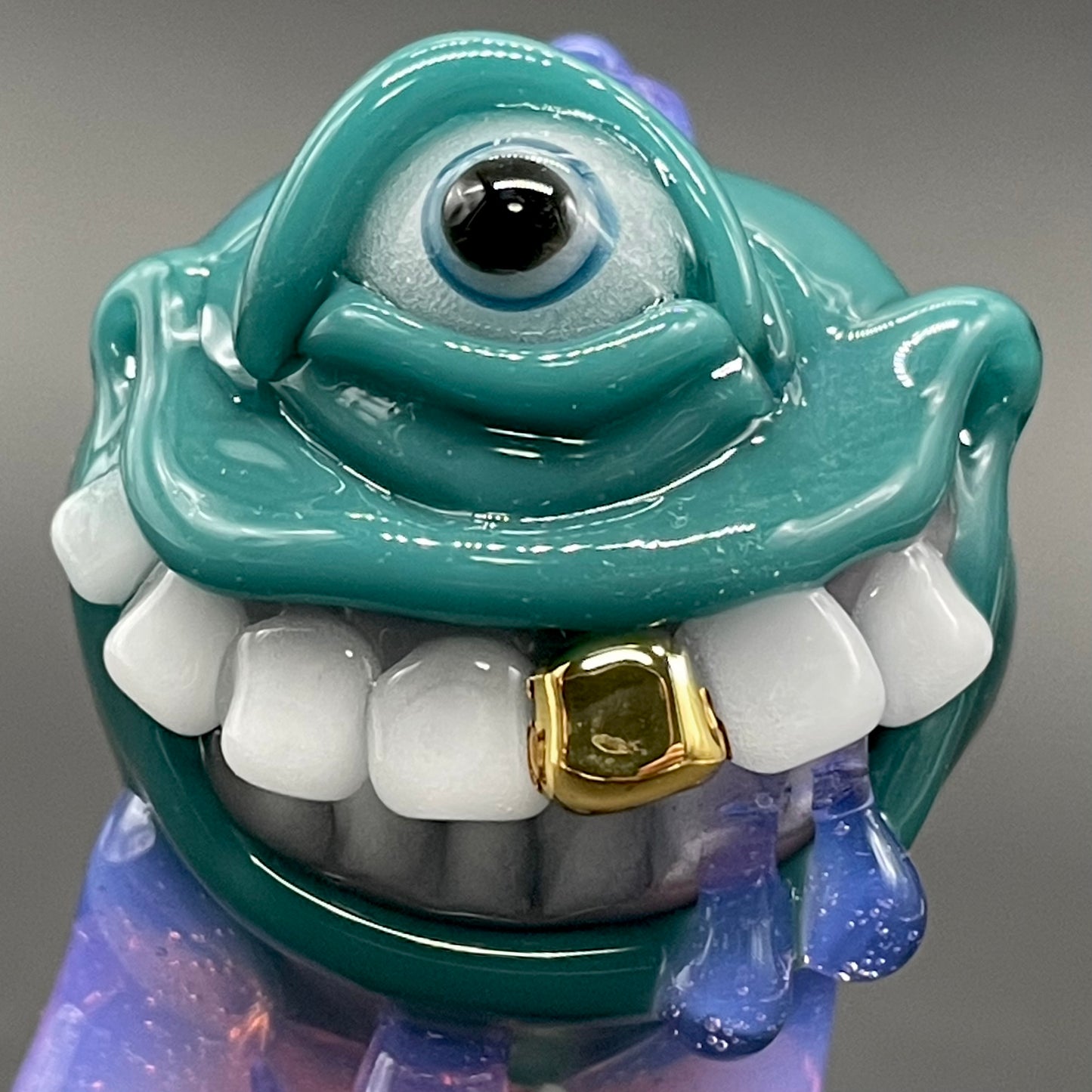 Dripping with sarcasm - Agua azule Drippy, grinning pendant