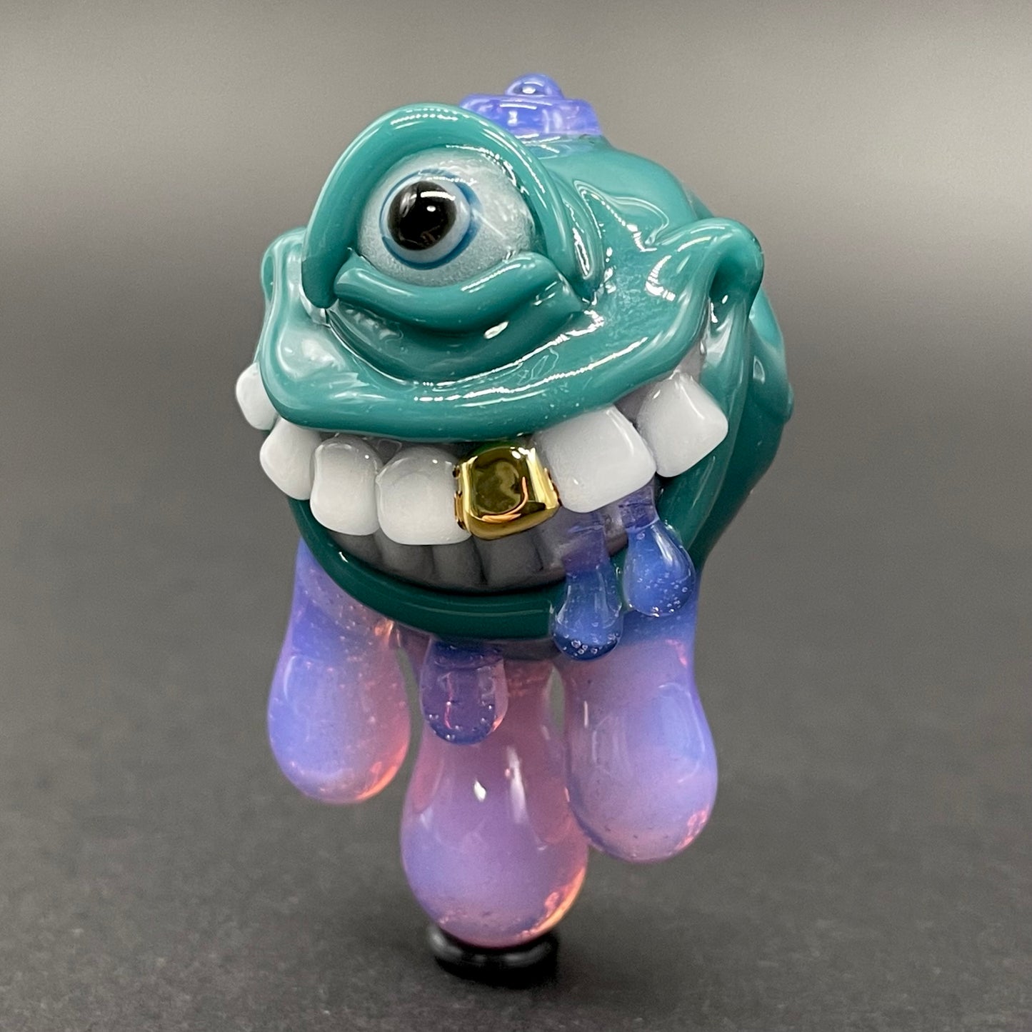 Dripping with sarcasm - Agua azule Drippy, grinning pendant