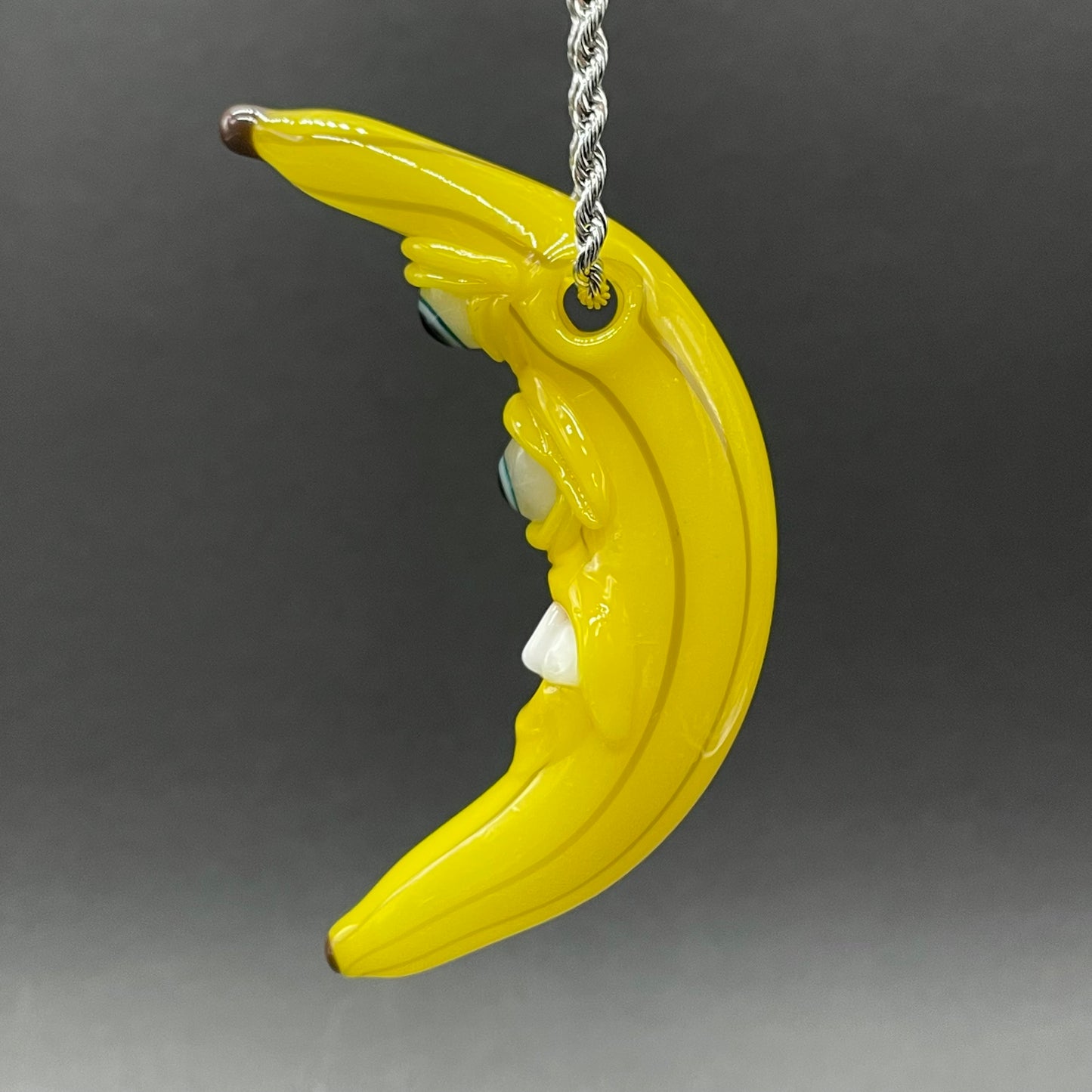 Grinning glass banana pendant