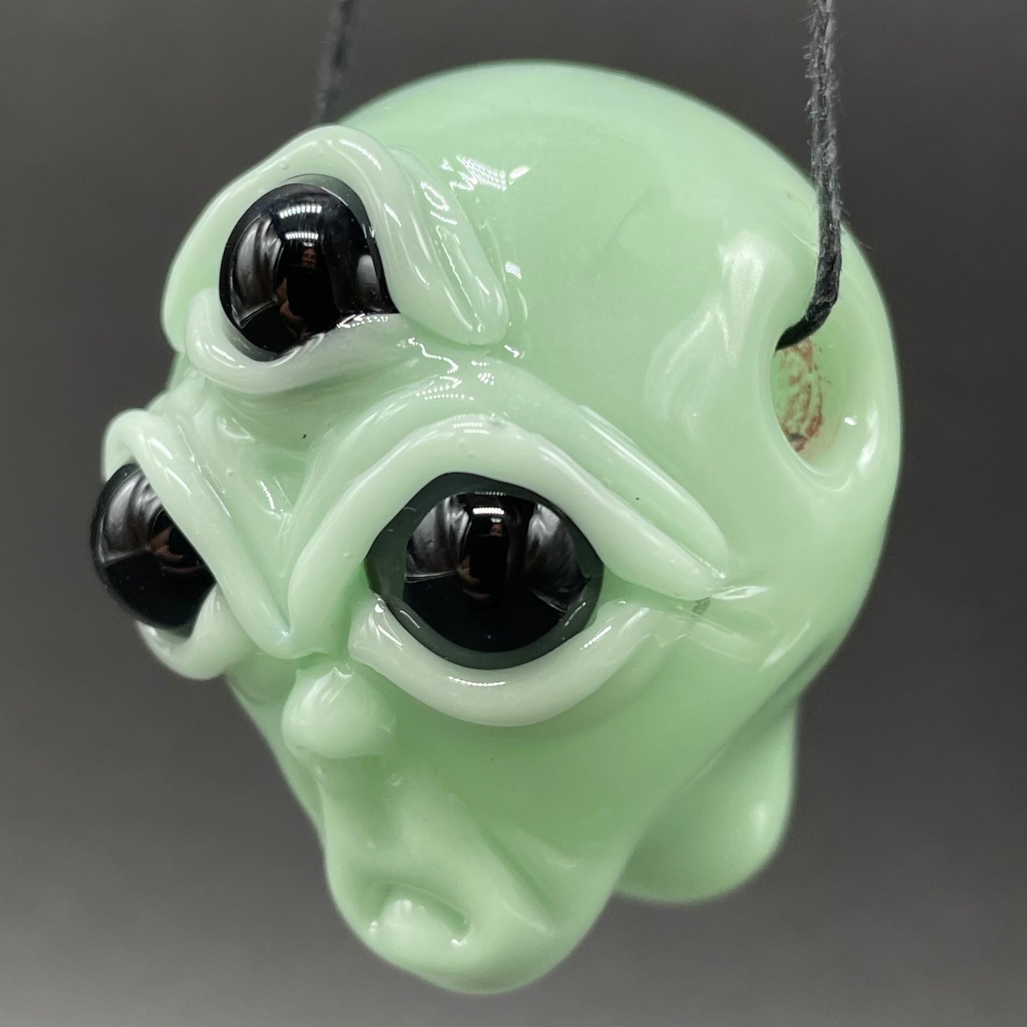 Time manipulating three eye glass alien pendant