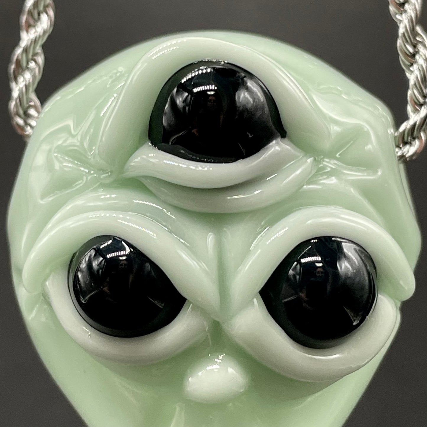 Time manipulating three eye glass alien pendant