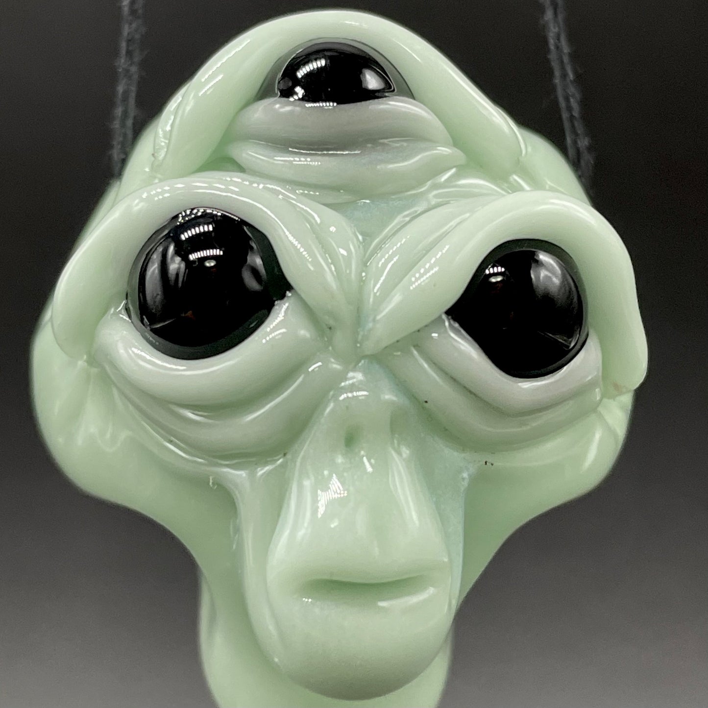 Time manipulating three eye glass alien pendant