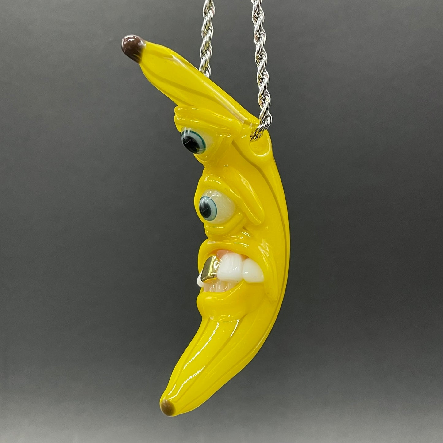 Grinning glass banana pendant