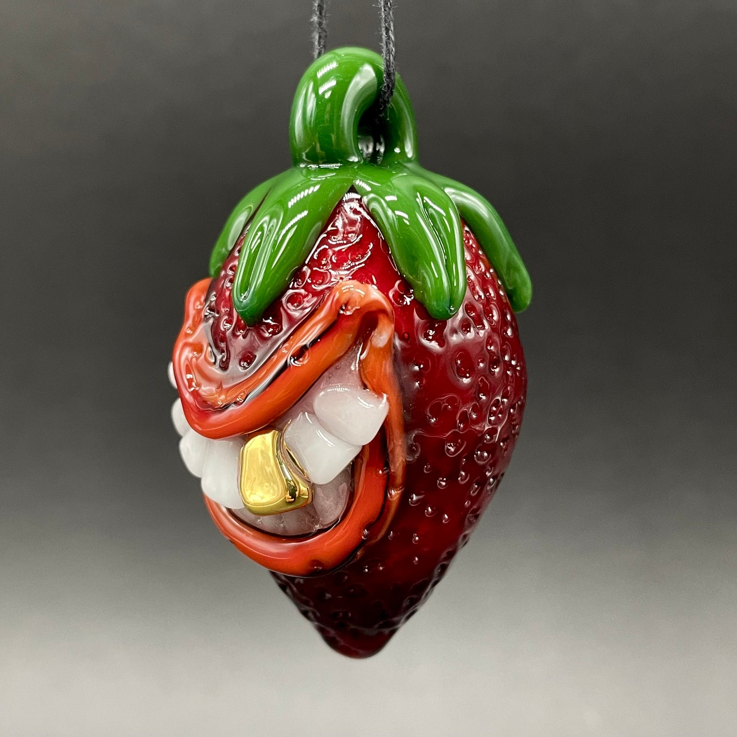 Toothy strawberry pendant