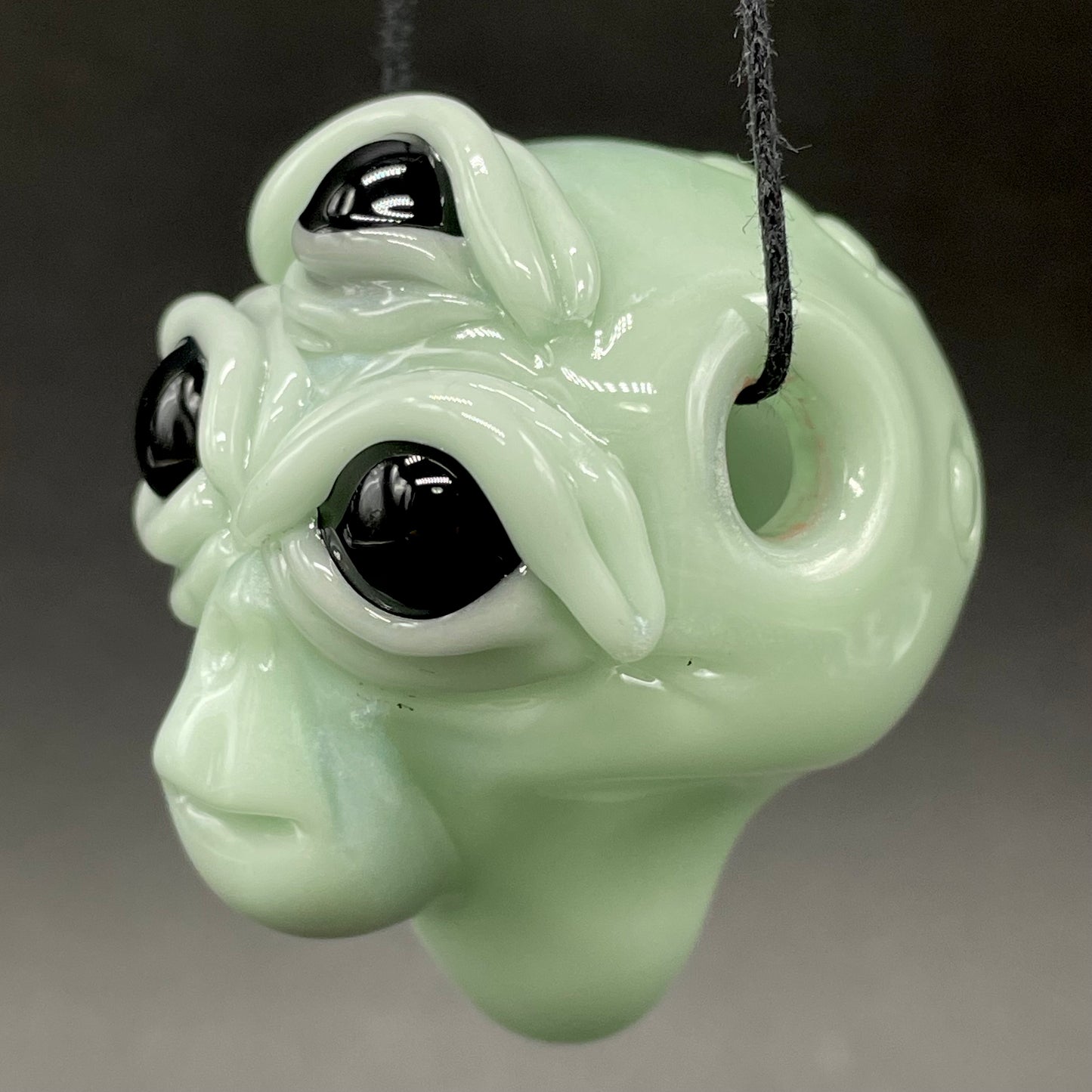 Time manipulating three eye glass alien pendant