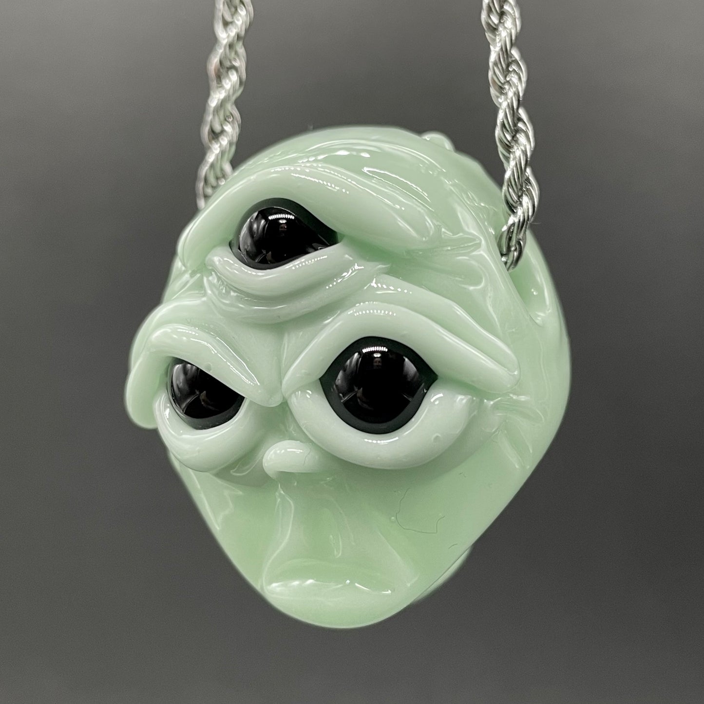 Time manipulating three eye glass alien pendant