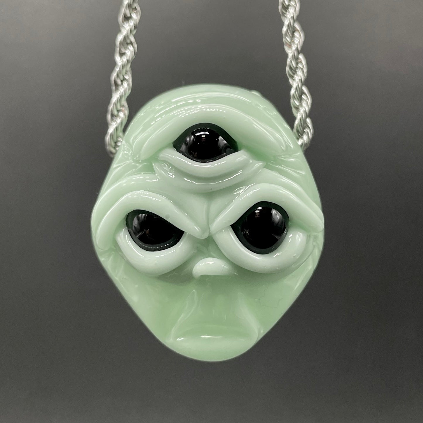 Time manipulating three eye glass alien pendant