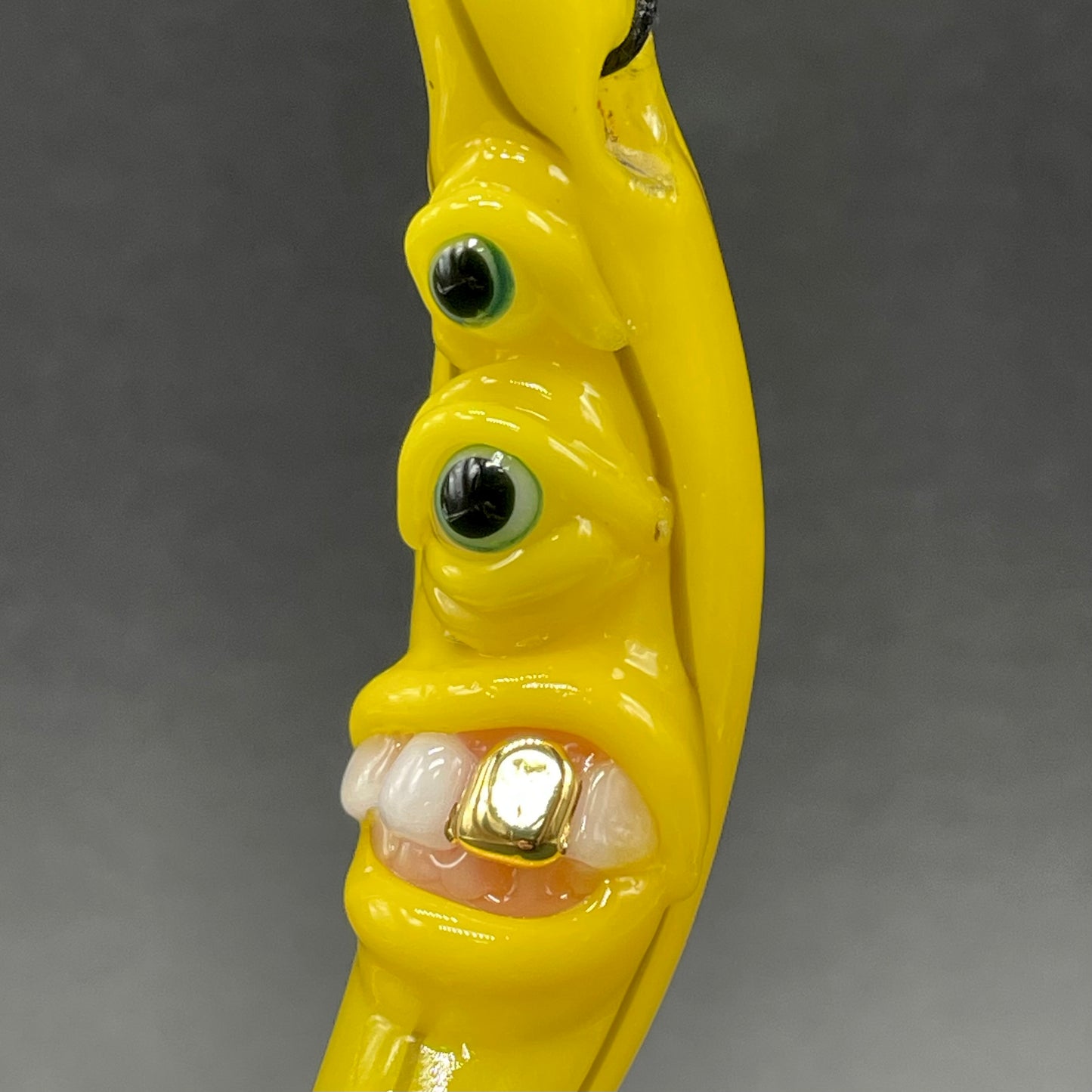 Grinning glass banana pendant