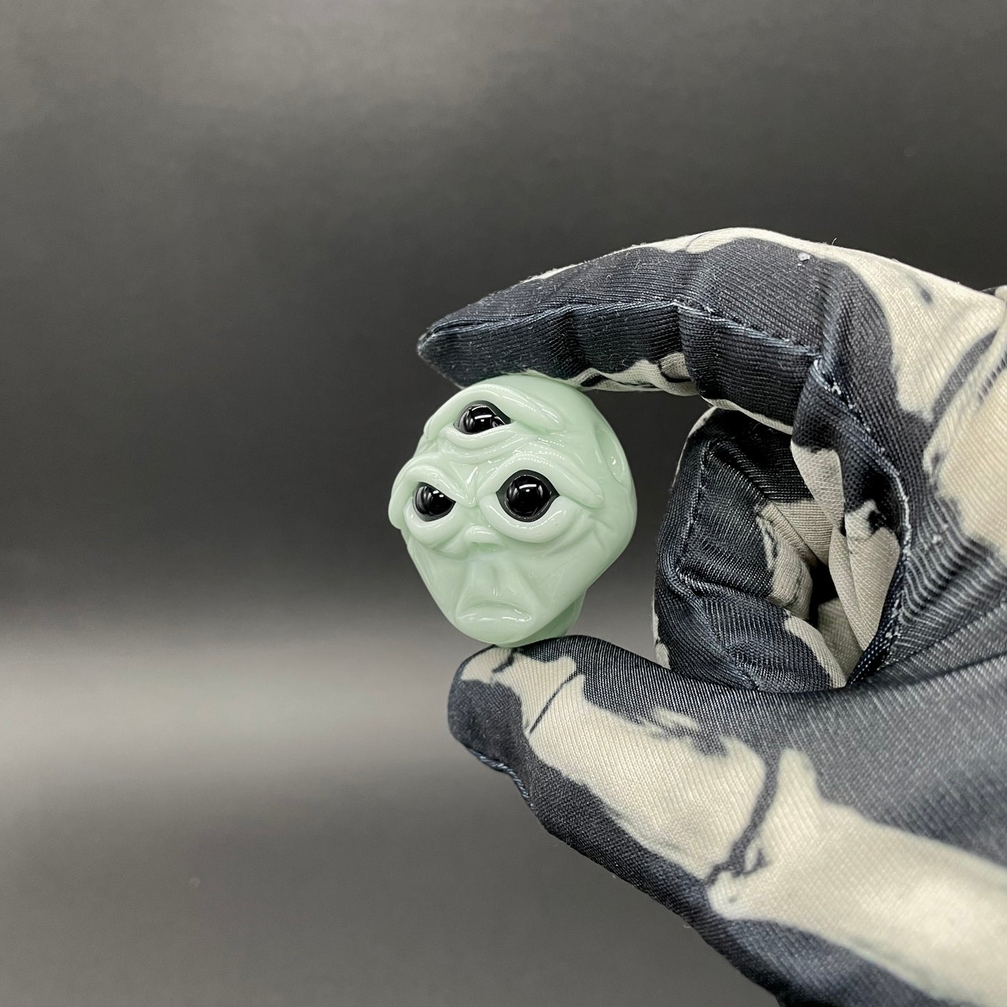 Time manipulating three eye glass alien pendant