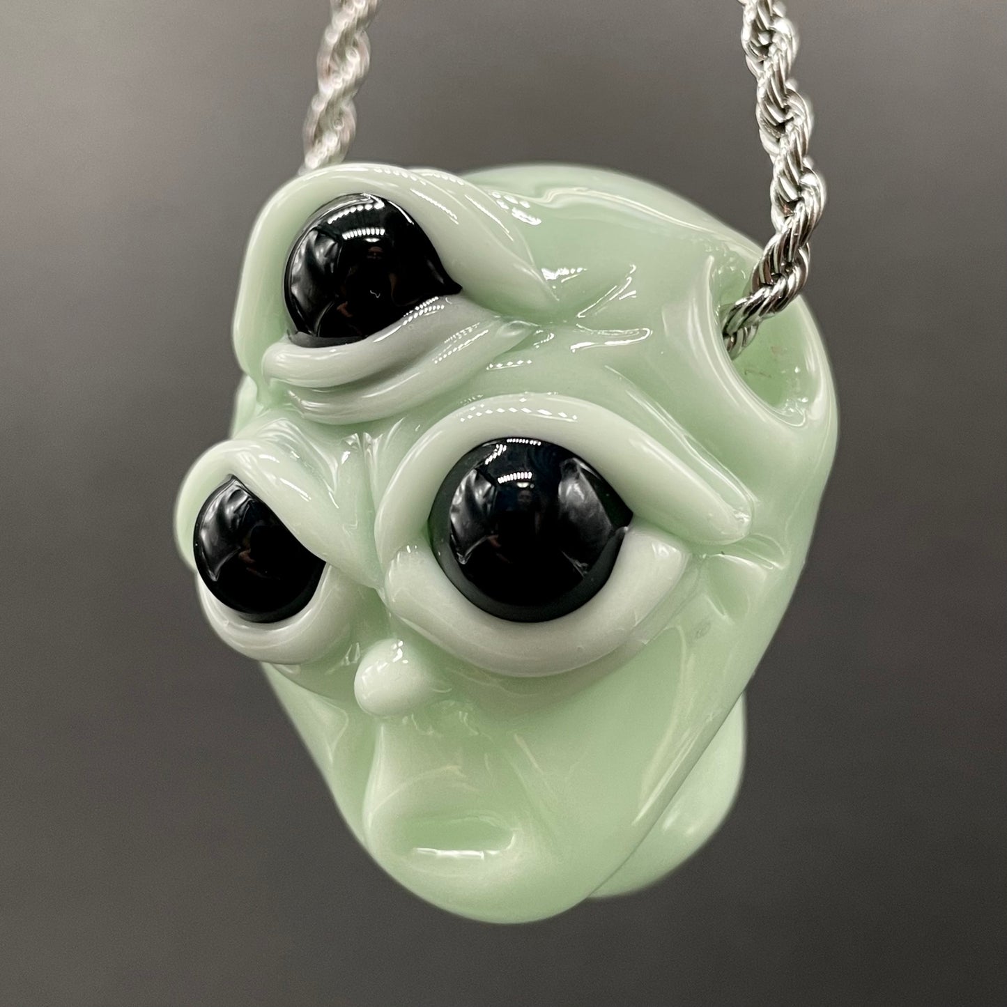 Time manipulating three eye glass alien pendant