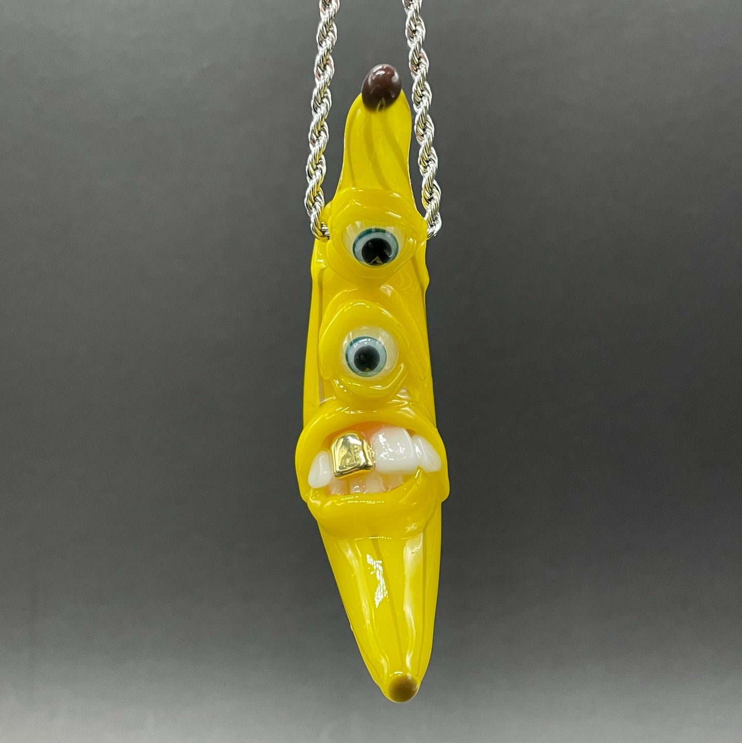 Grinning glass banana pendant