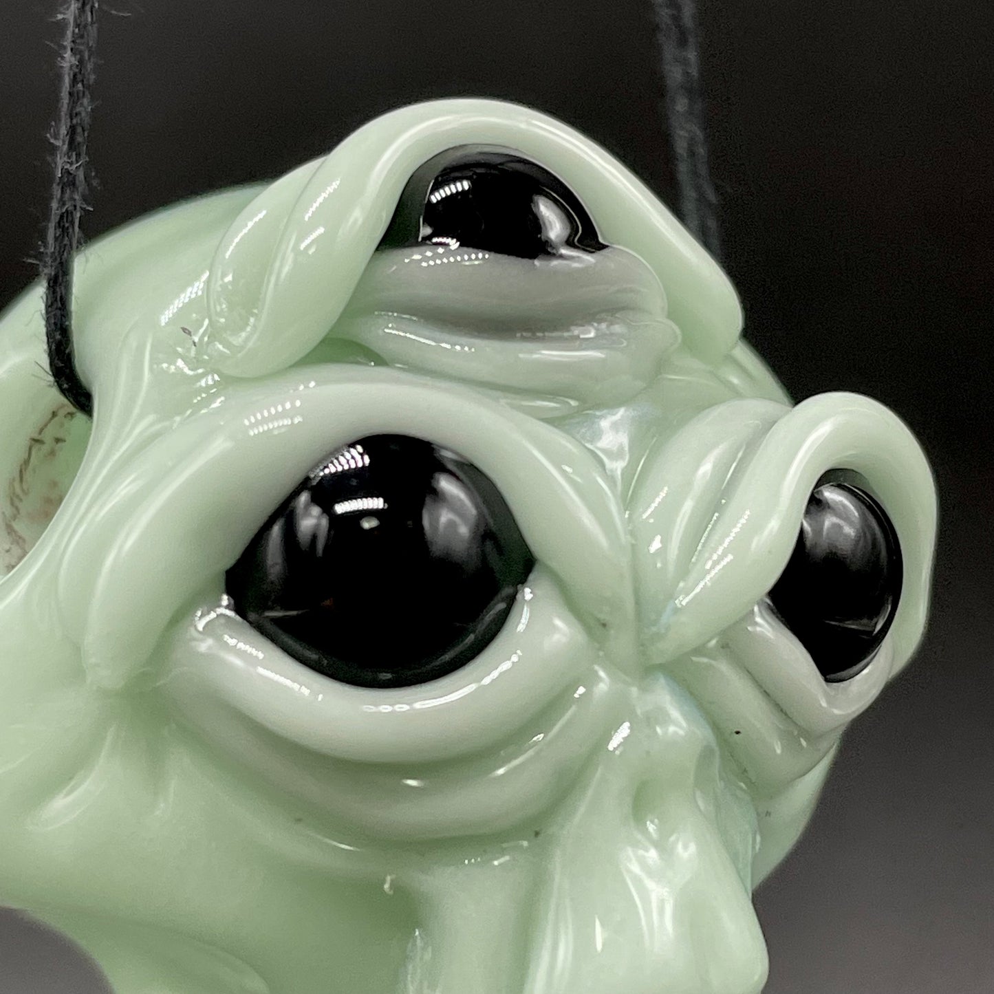Time manipulating three eye glass alien pendant