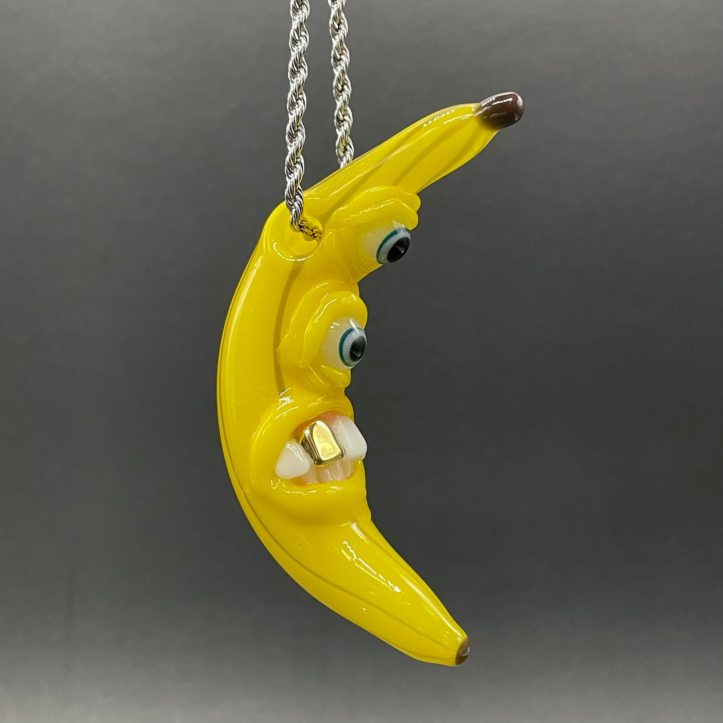 Grinning glass banana pendant