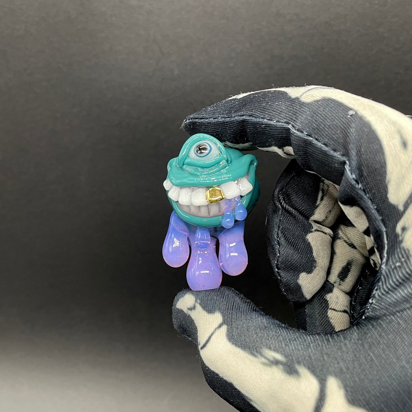 Dripping with sarcasm - Agua azule Drippy, grinning pendant