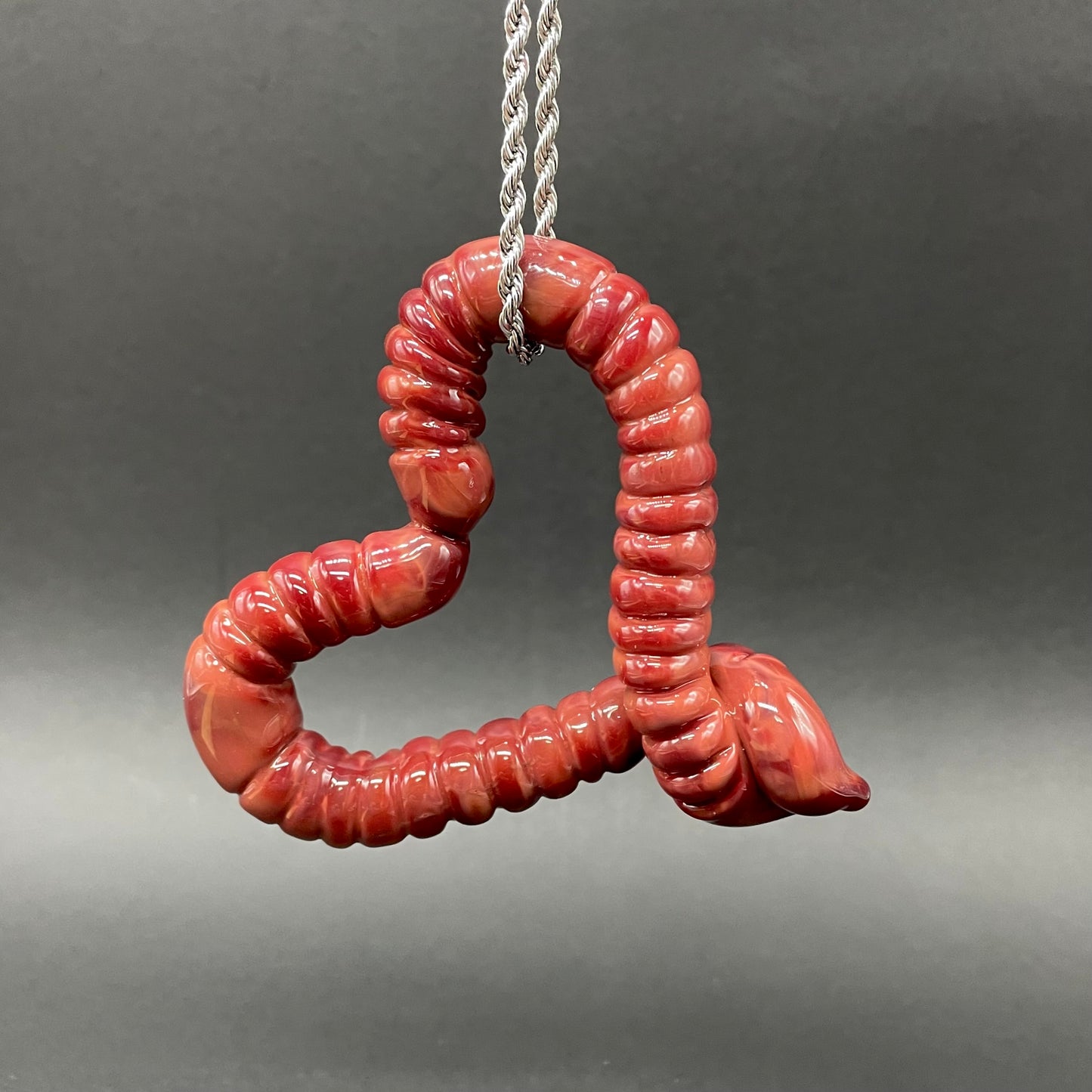Large glass earthworm heart shaped pendant detail view - premium glass art