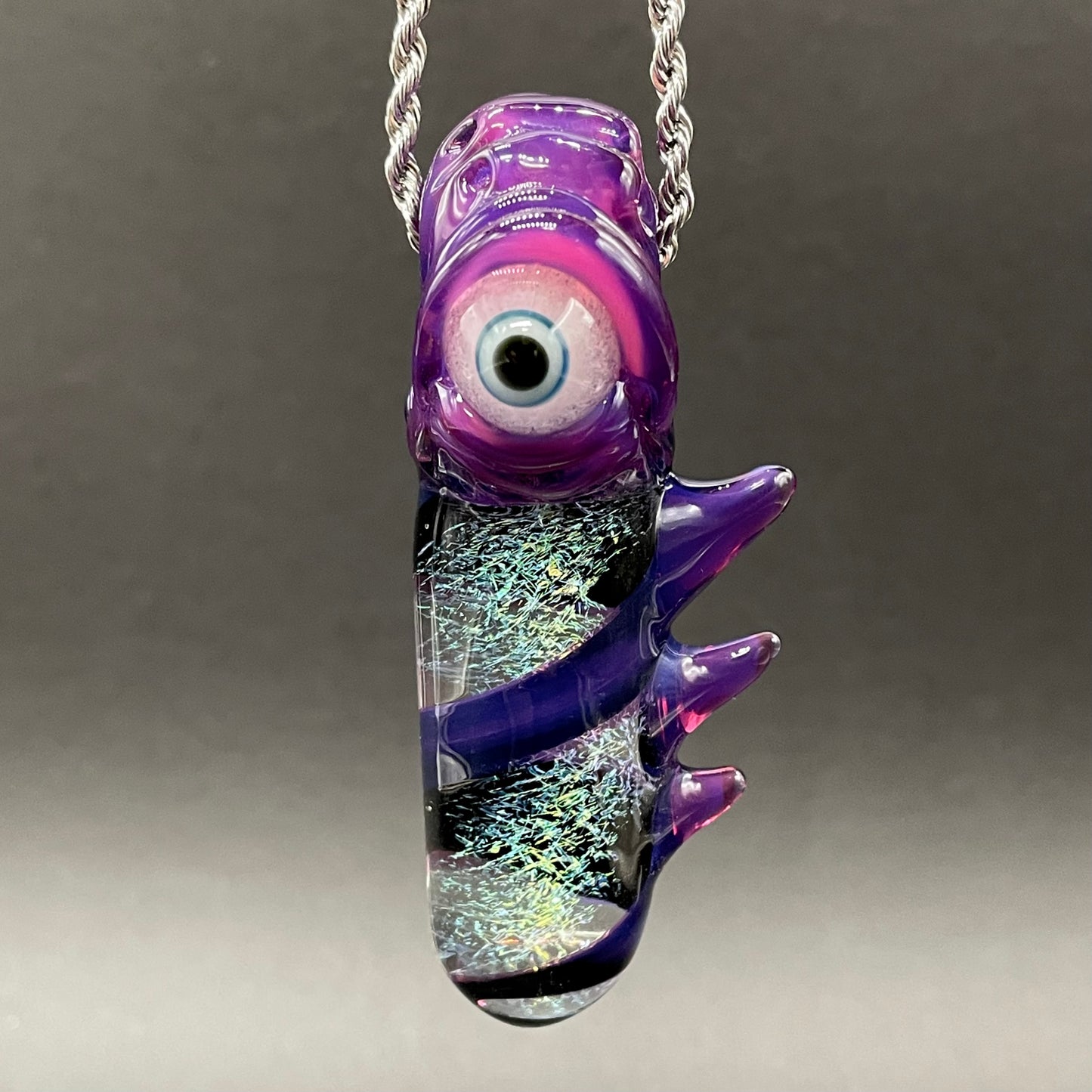 Close-up of Royal jelly dichroic cyclops pendant - handcrafted glass
