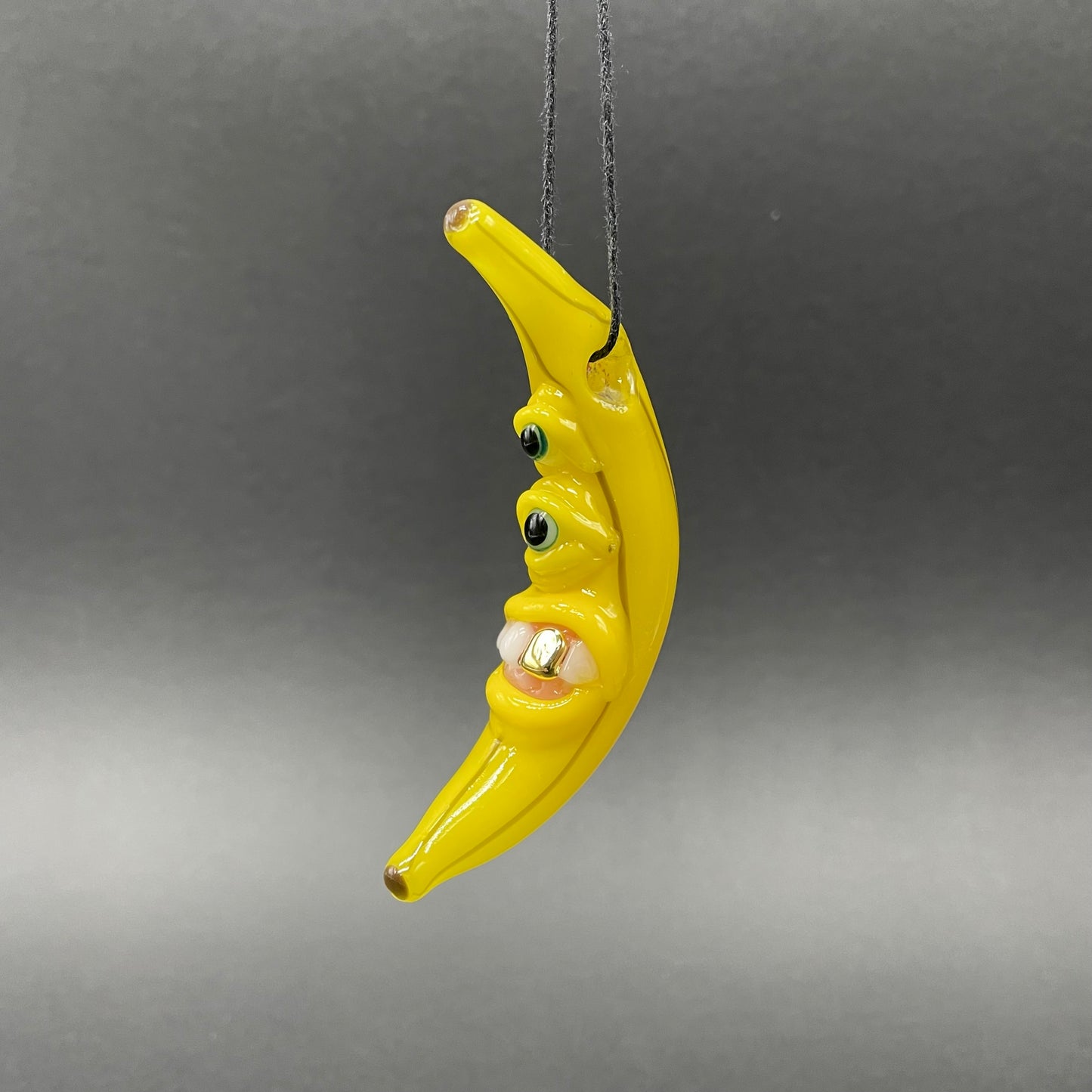 Grinning glass banana pendant